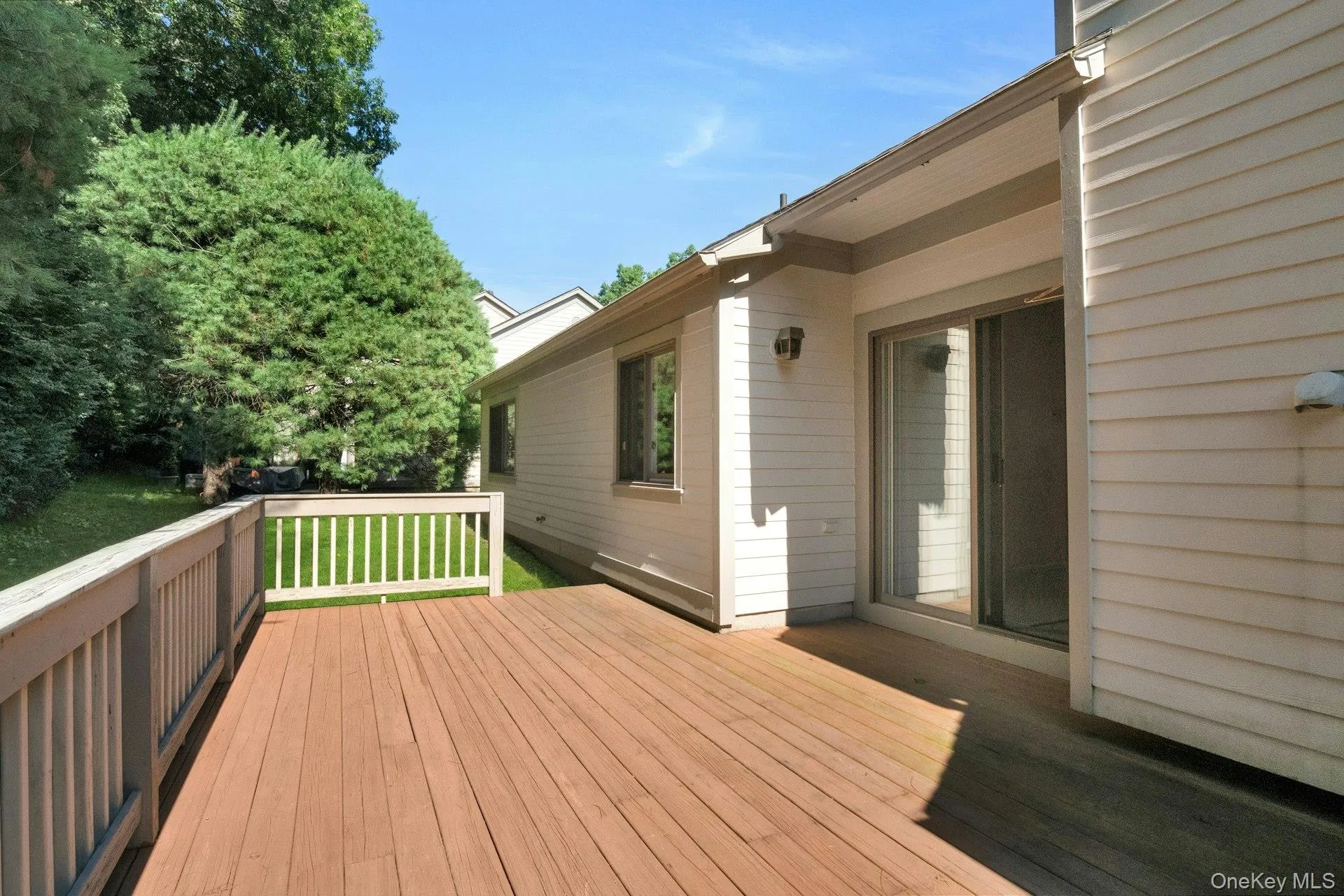 Oversized deck from the sliding glass doors in the Living room & access to private yard Oversized deck from the sliding glass doors in the Living room & access to private yard