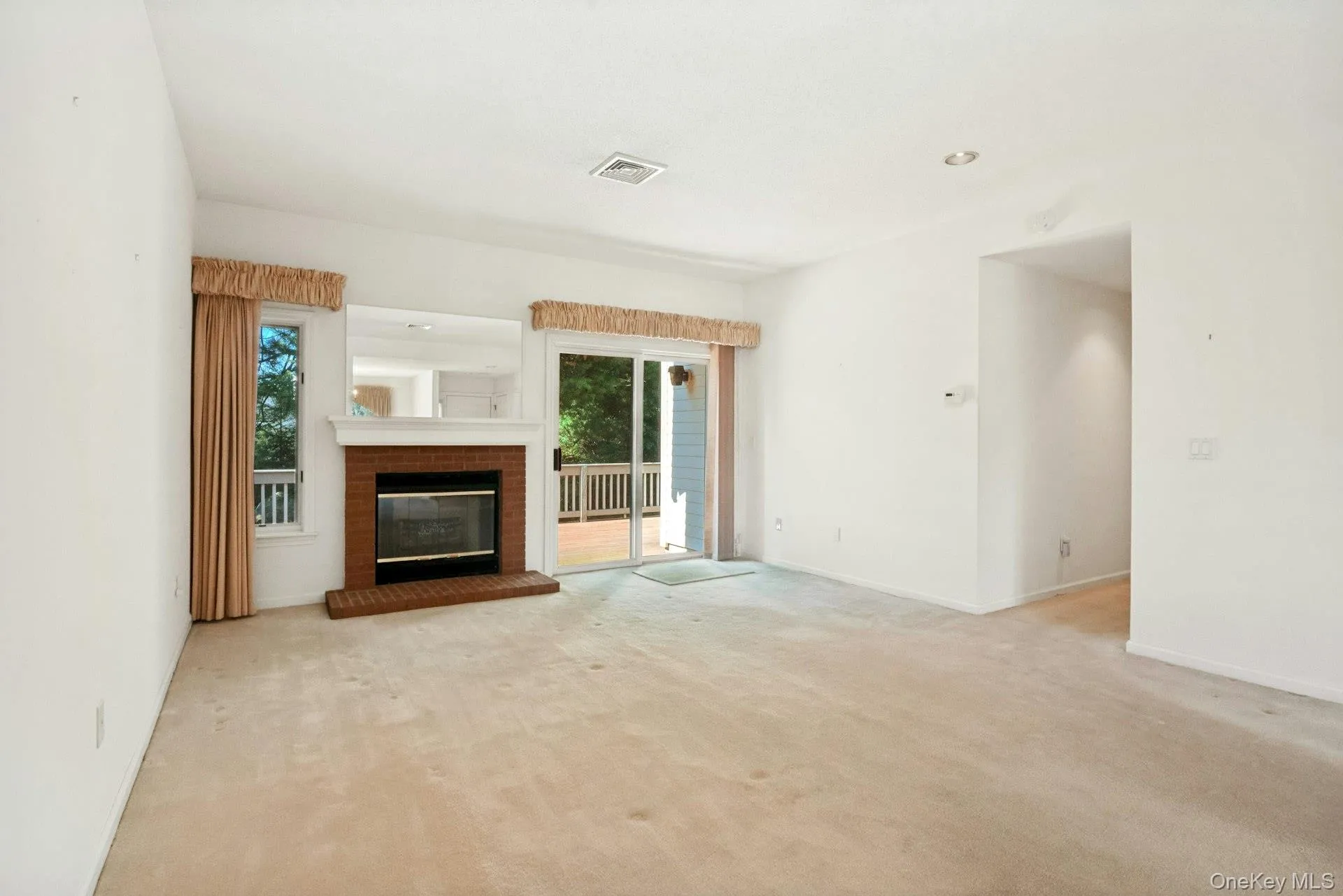 Living room with fireplace*,recessed lights & view to hallway/laundry/ bedroom area Living room with fireplace*,recessed lights & view to hallway/laundry/ bedroom area