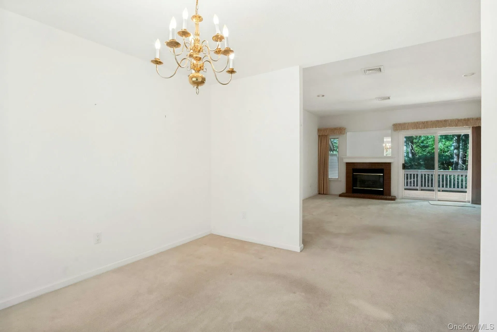 With view to living room with fireplace* & sliding glass doors to rear deck and yard*fireplace has not been used.. With view to living room with fireplace* & sliding glass doors to rear deck and yard*fireplace has not been used..