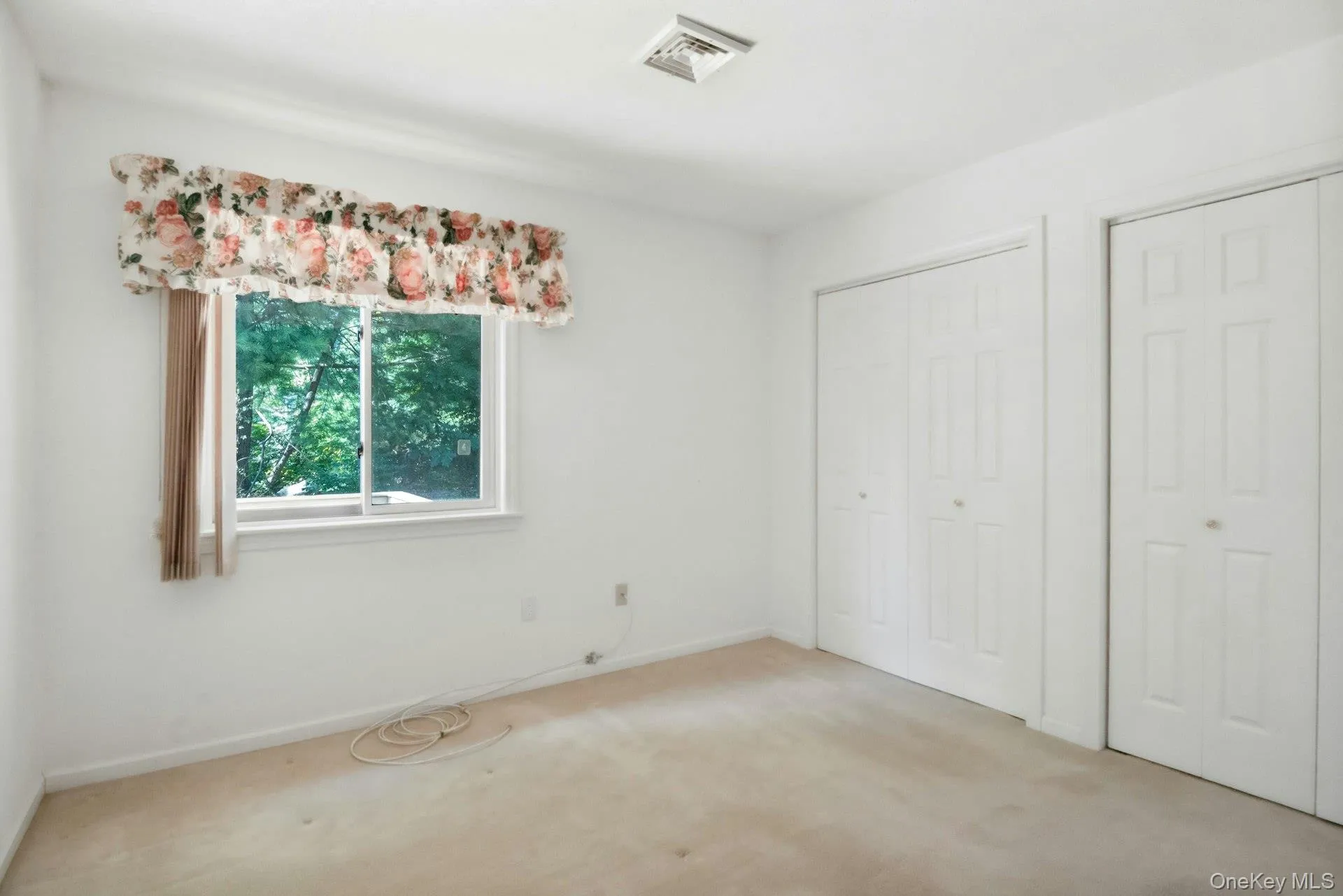 Second bedroom w view of the yard & double closets Second bedroom w view of the yard & double closets