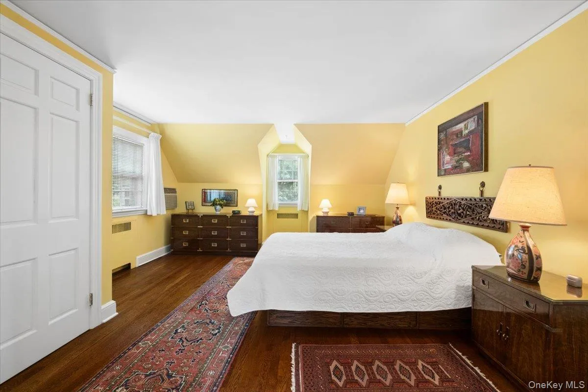 Spacious Primary Bedroom with Beautiful Oak Floors and Multiple Windows Offering Gentle Daylight and Airflow. Spacious Primary Bedroom with Beautiful Oak Floors and Multiple Windows Offering Gentle Daylight and Airflow.