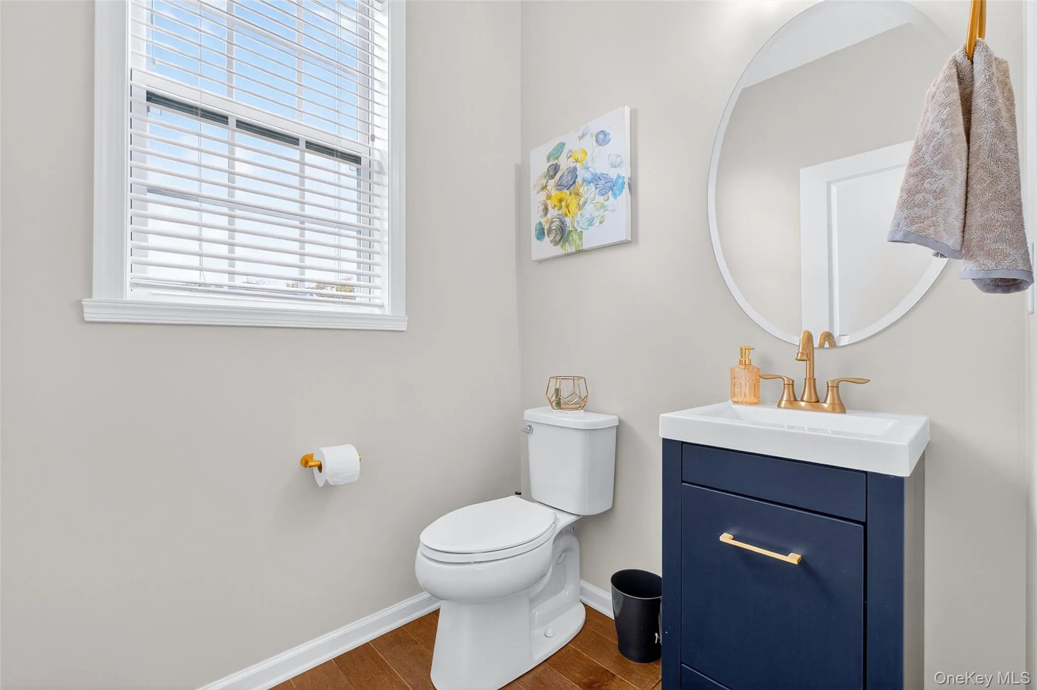 Half bathroom featuring vanity and dark wood-style flooring Half bathroom featuring vanity and dark wood-style flooring