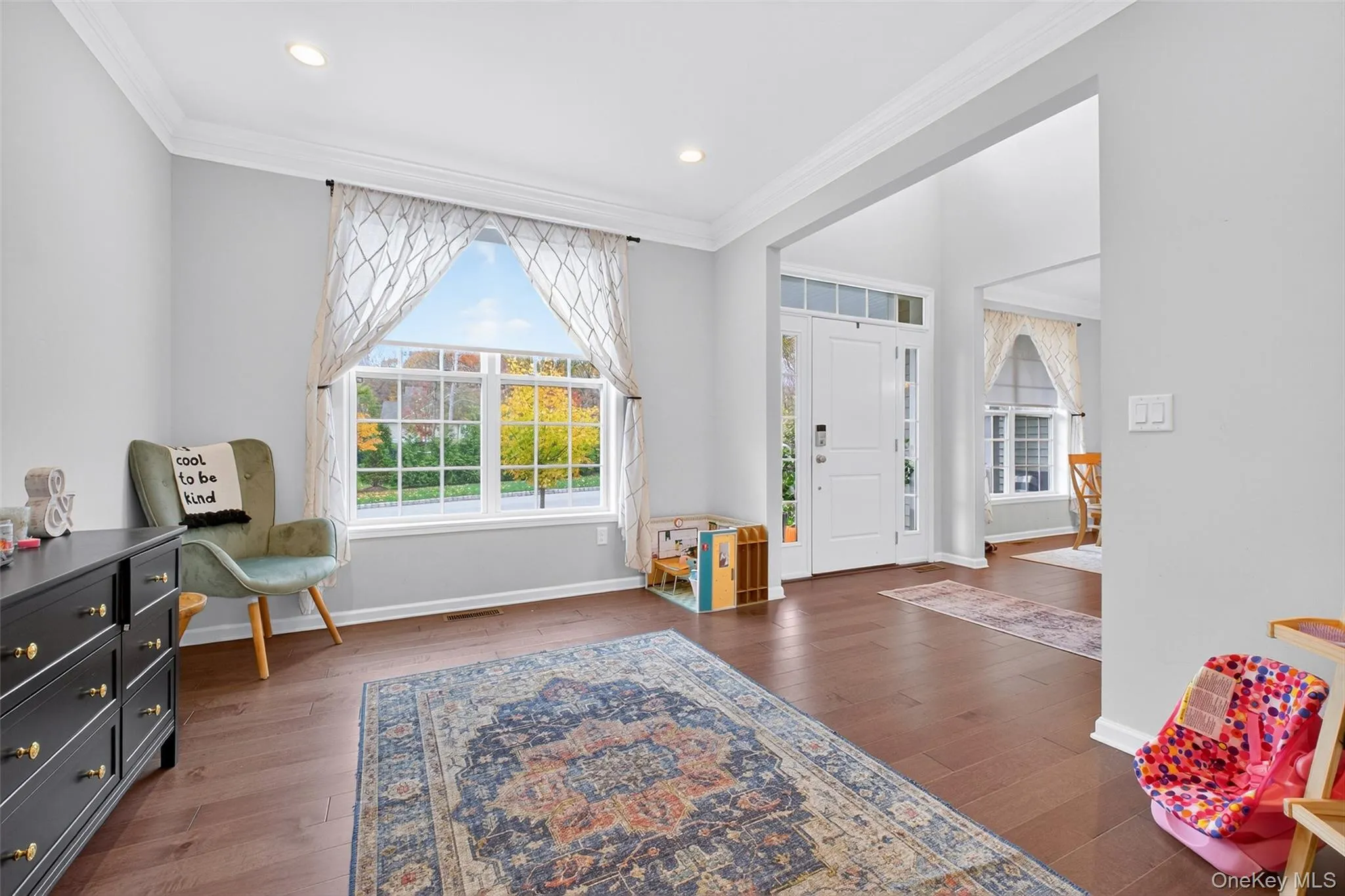 Entryway with ornamental molding, lots of natural light, dark wood finished floors, and recessed lighting Entryway with ornamental molding, lots of natural light, dark wood finished floors, and recessed lighting