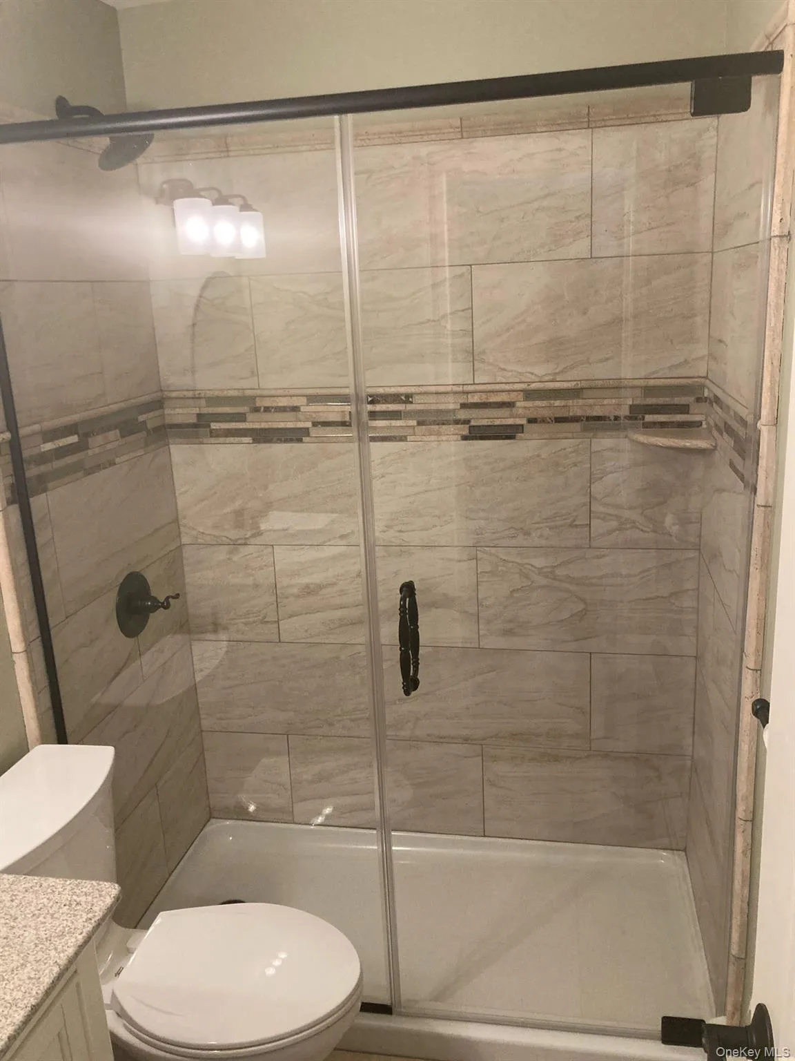 Bathroom with vanity and a stall shower Bathroom with vanity and a stall shower