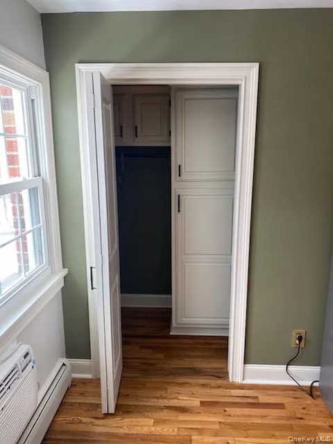 Closet with baseboard heating and a wall mounted AC Closet with baseboard heating and a wall mounted AC