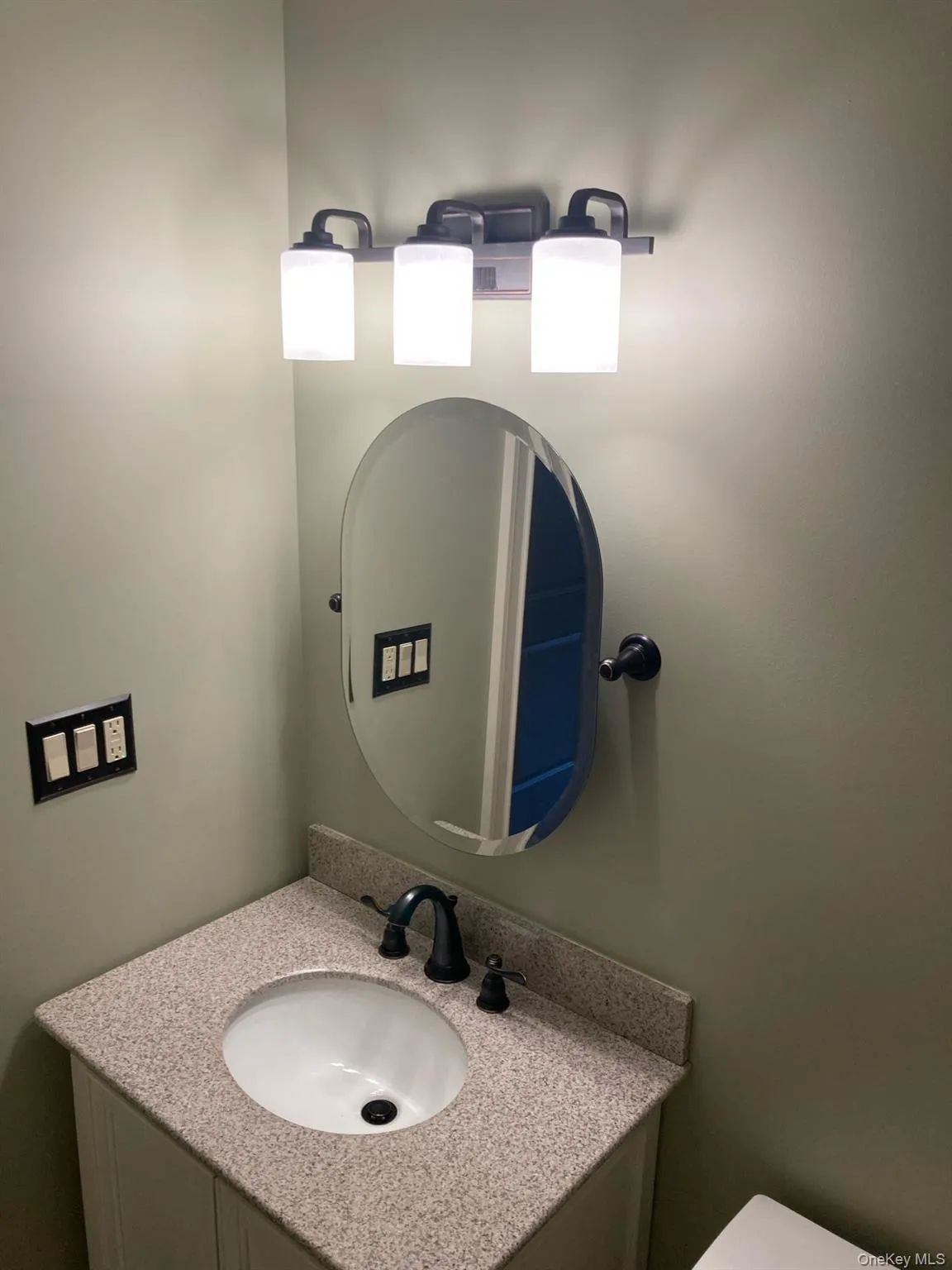 Half bathroom with vanity and toilet Half bathroom with vanity and toilet
