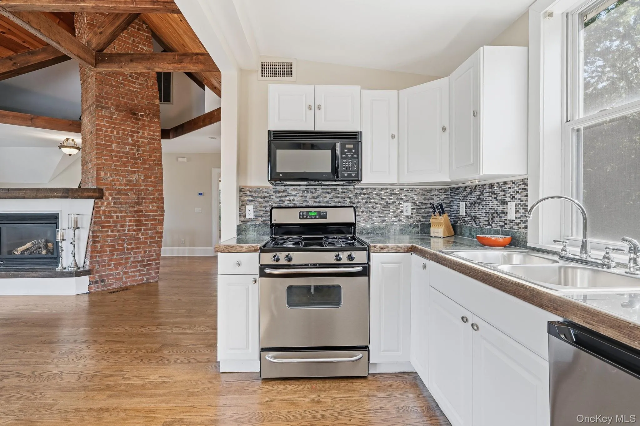Current Kitchen- bright white kitchen with picture window features stainless steel appliances. (Remodeling will be complete prior to move-in). Current Kitchen- bright white kitchen with picture window features stainless steel appliances. (Remodeling will be complete prior to move-in).