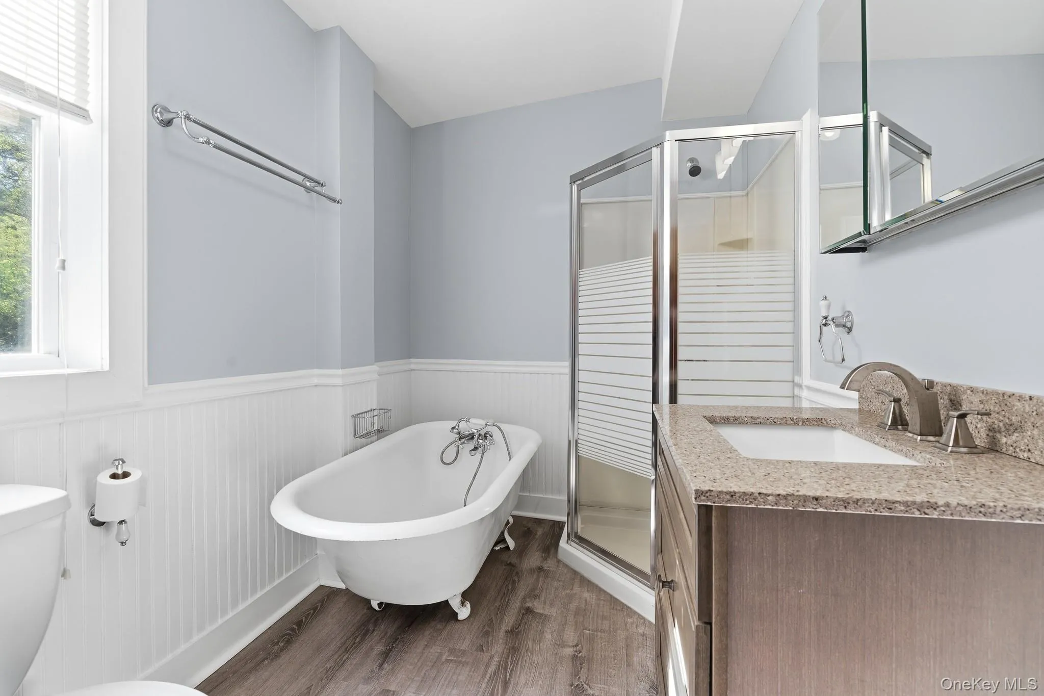 The huge bathroom features a claw-foot tub and a shower along with plenty of light. The huge bathroom features a claw-foot tub and a shower along with plenty of light.