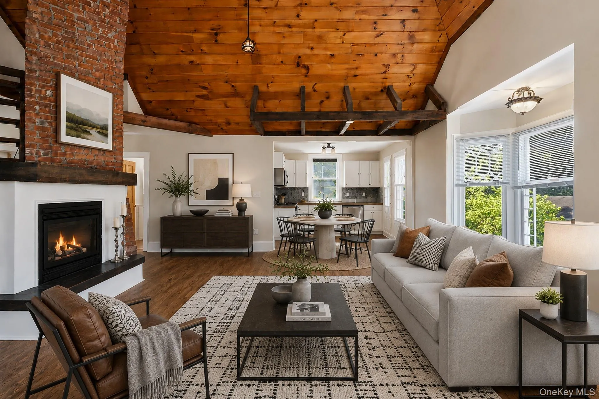 Virtually Staged. The bright and airy living room features vaulted wood-plank ceiling with exposed beams, big bright windows from every angle, bay windows, working fireplace, and original hardwood flooring. Virtually Staged. The bright and airy living room features vaulted wood-plank ceiling with exposed beams, big bright windows from every angle, bay windows, working fireplace, and original hardwood flooring.
