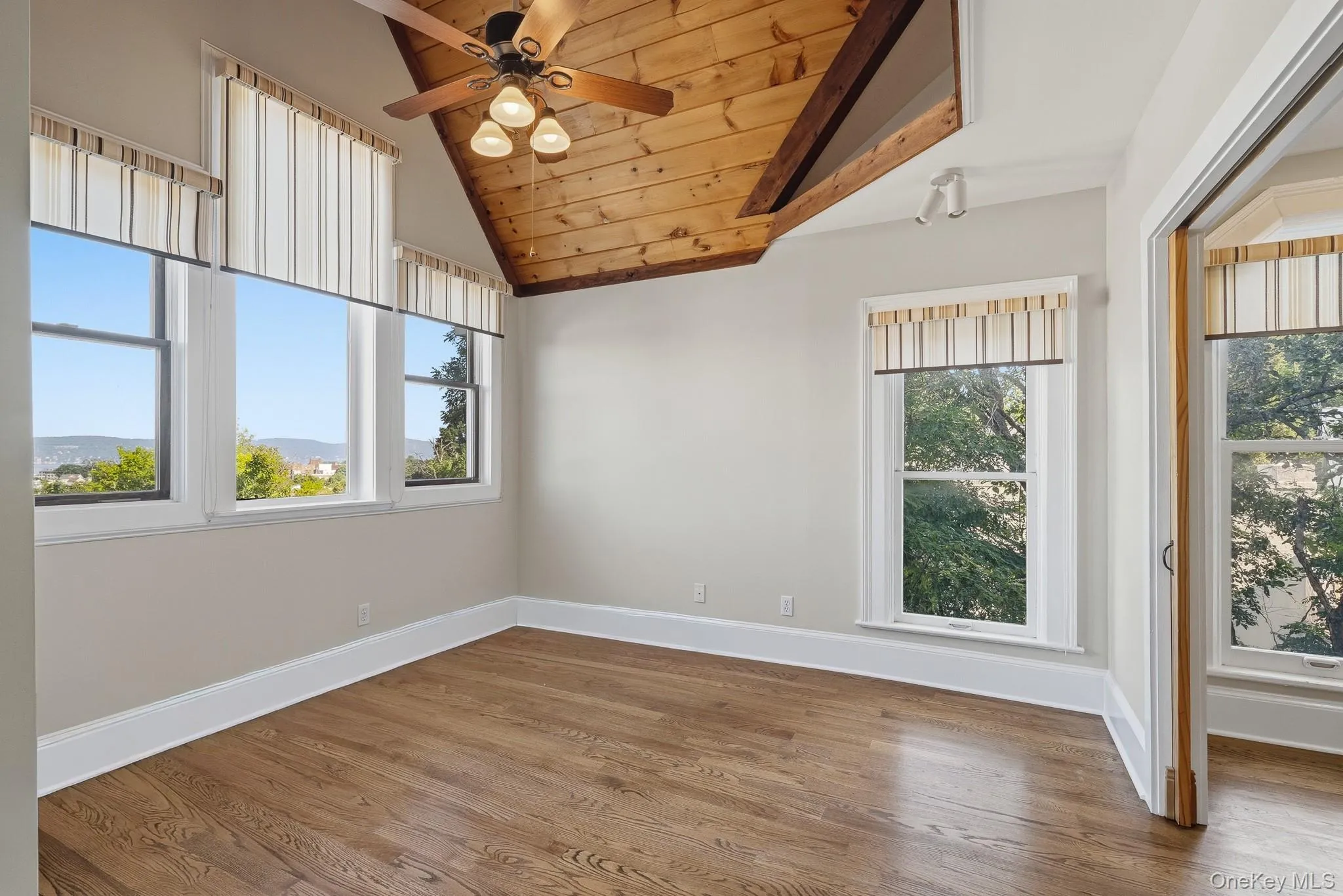 The front bedroom features windows on all sides, gorgeous light from every exposure, large closet, fan and original hardwood floors. The front bedroom features windows on all sides, gorgeous light from every exposure, large closet, fan and original hardwood floors.