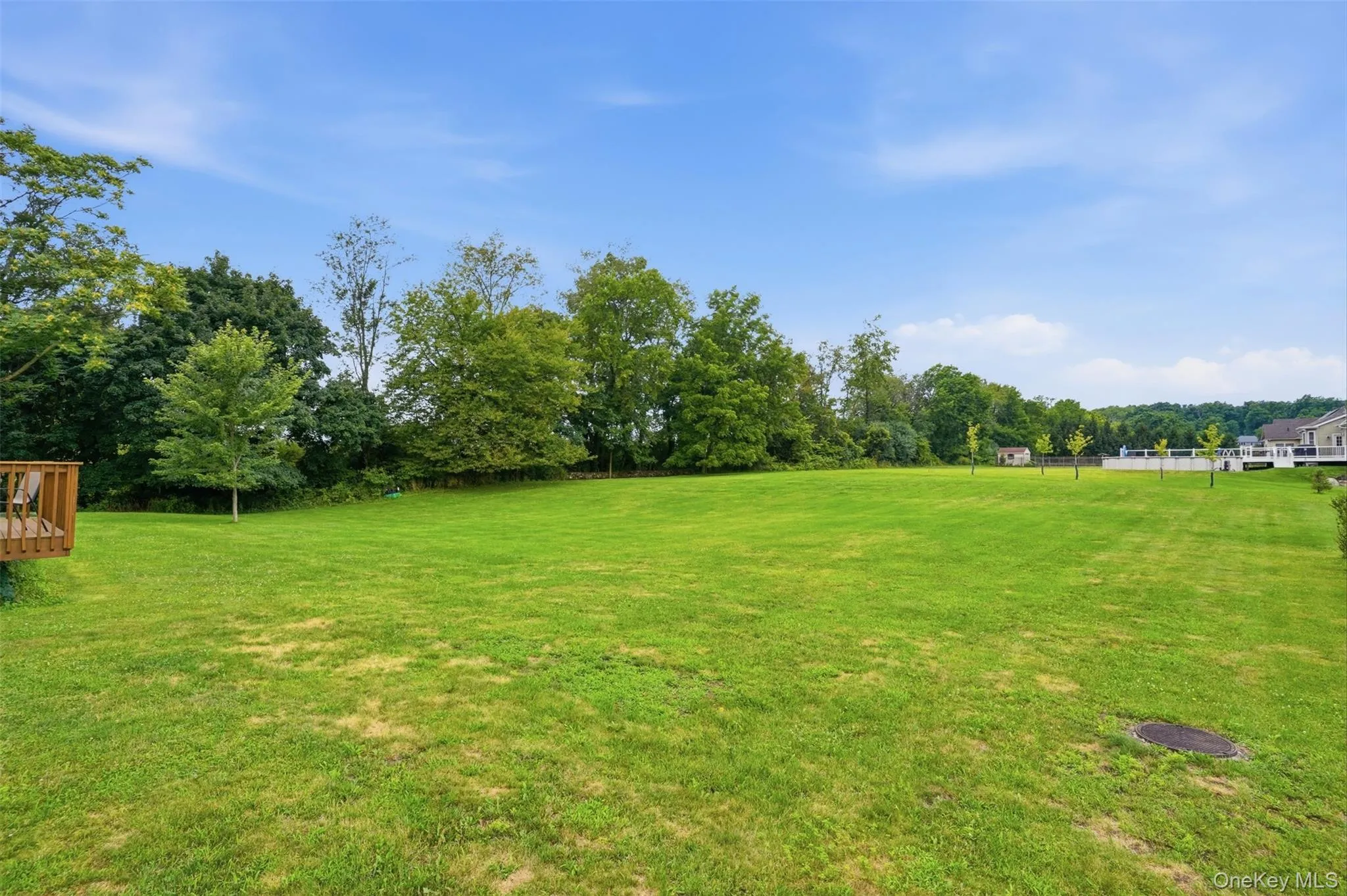 Expansive green lawn providing ample outdoor space Expansive green lawn providing ample outdoor space