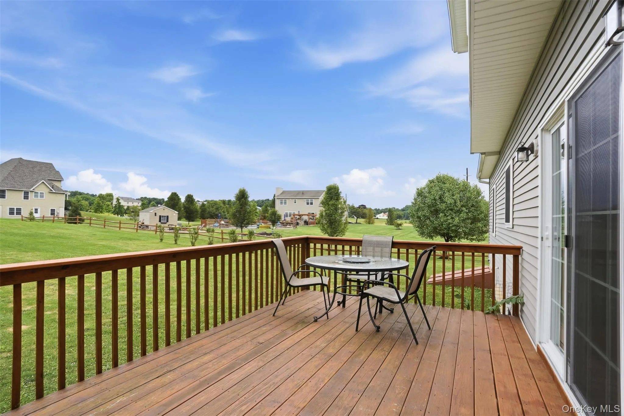 Spacious wood-finish deck with a wood railing system Spacious wood-finish deck with a wood railing system