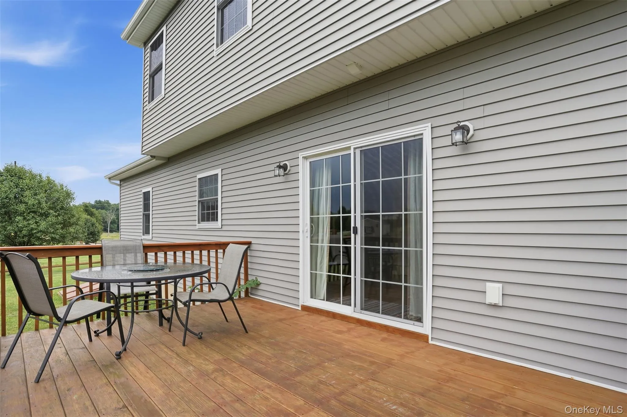 Spacious wood-finish deck with a wood railing system Spacious wood-finish deck with a wood railing system