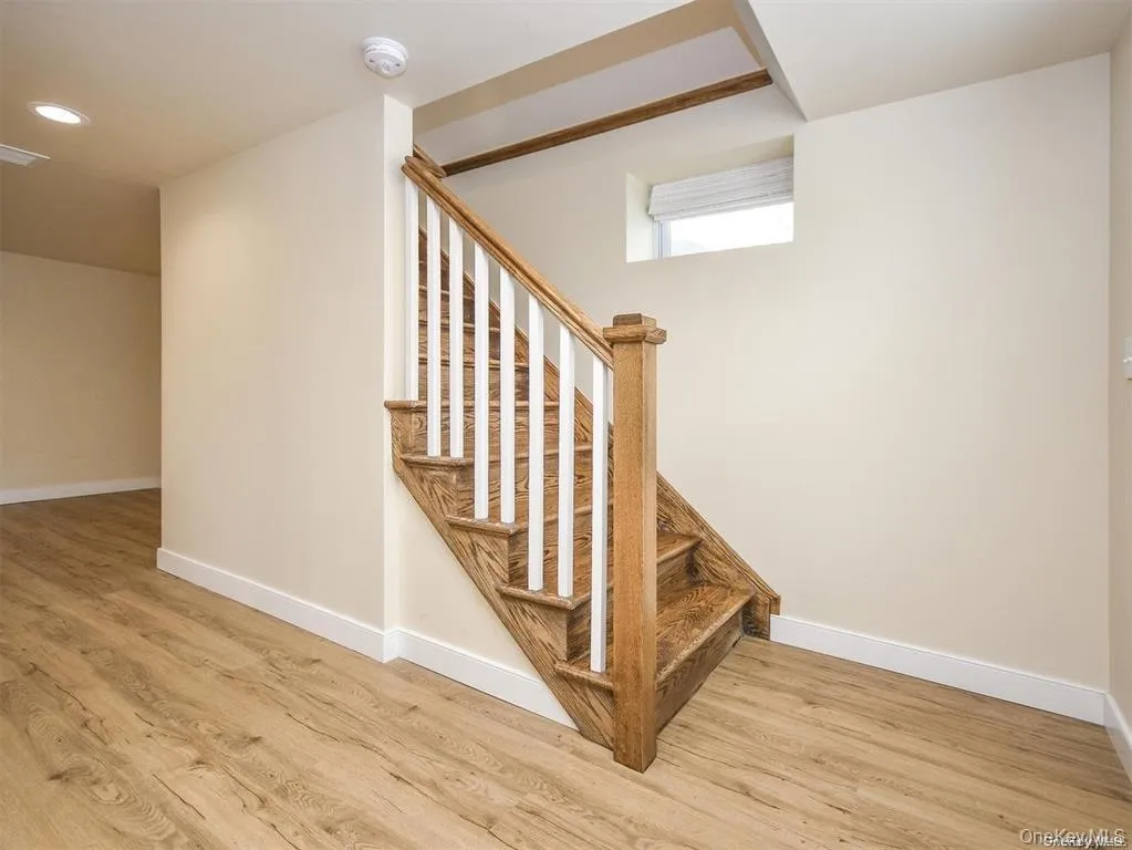 Stairway with wood finished floors and recessed lighting Stairway with wood finished floors and recessed lighting