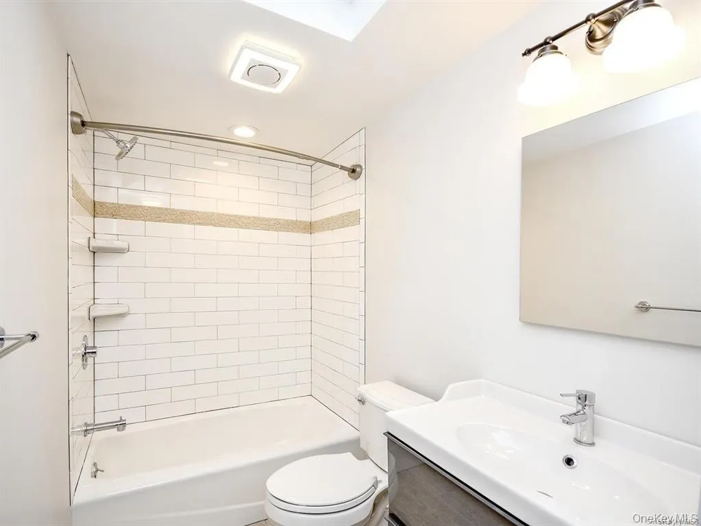 Full bathroom featuring vanity and shower / tub combination Full bathroom featuring vanity and shower / tub combination