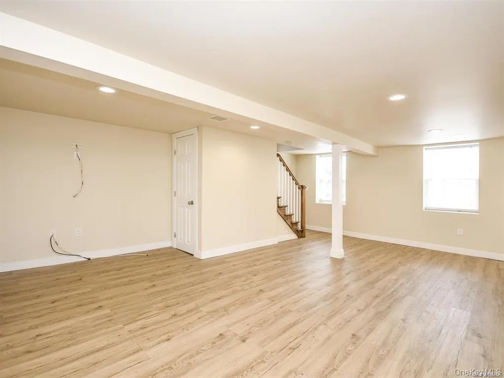 Below grade area featuring stairs, light wood finished floors, recessed lighting, and healthy amount of natural light Below grade area featuring stairs, light wood finished floors, recessed lighting, and healthy amount of natural light