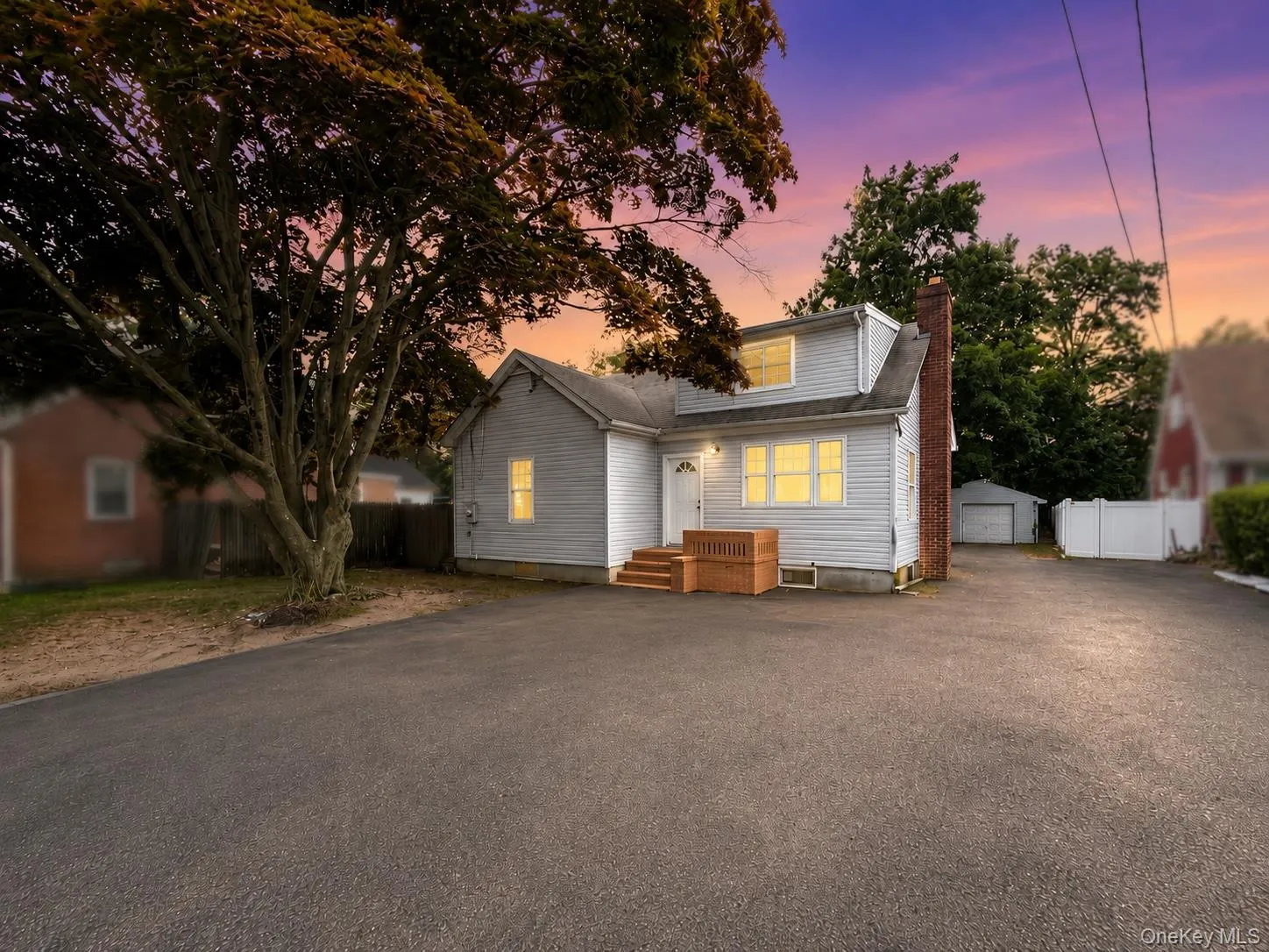 Twilight enhanced. Front of the house. Deep parking - 2 car garage towards the back with additional storage. Twilight enhanced. Front of the house. Deep parking - 2 car garage towards the back with additional storage.