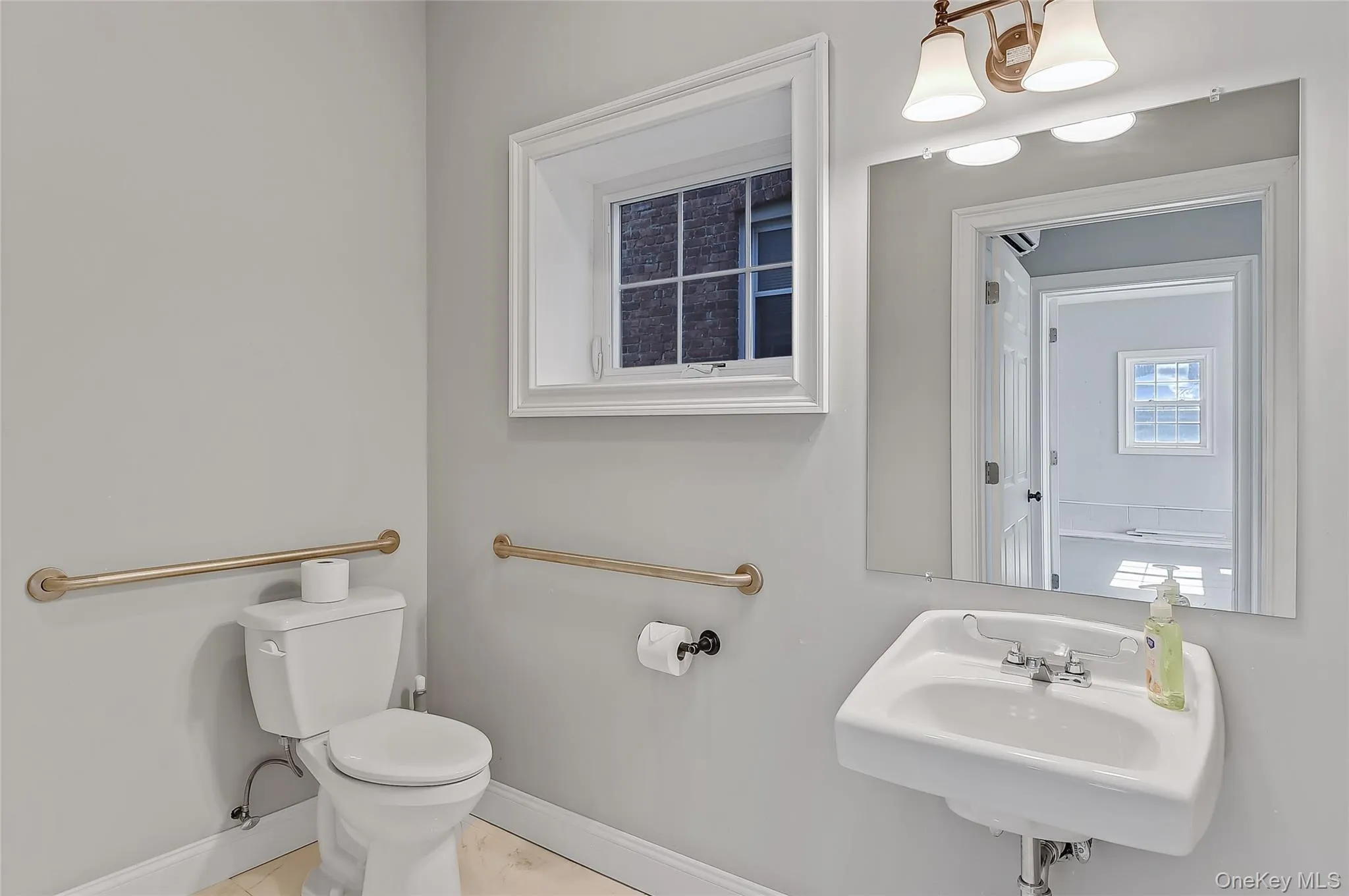 Bathroom featuring baseboards and light tile patterned floors Bathroom featuring baseboards and light tile patterned floors
