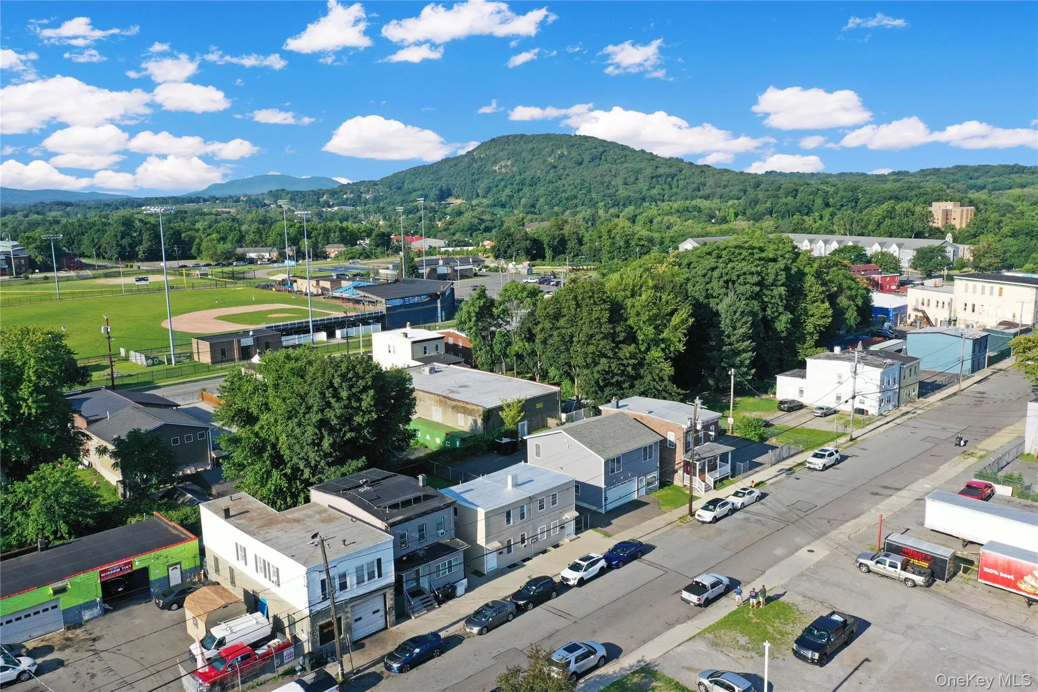 Bird's eye view of a heavily wooded area and mountains Bird's eye view of a heavily wooded area and mountains