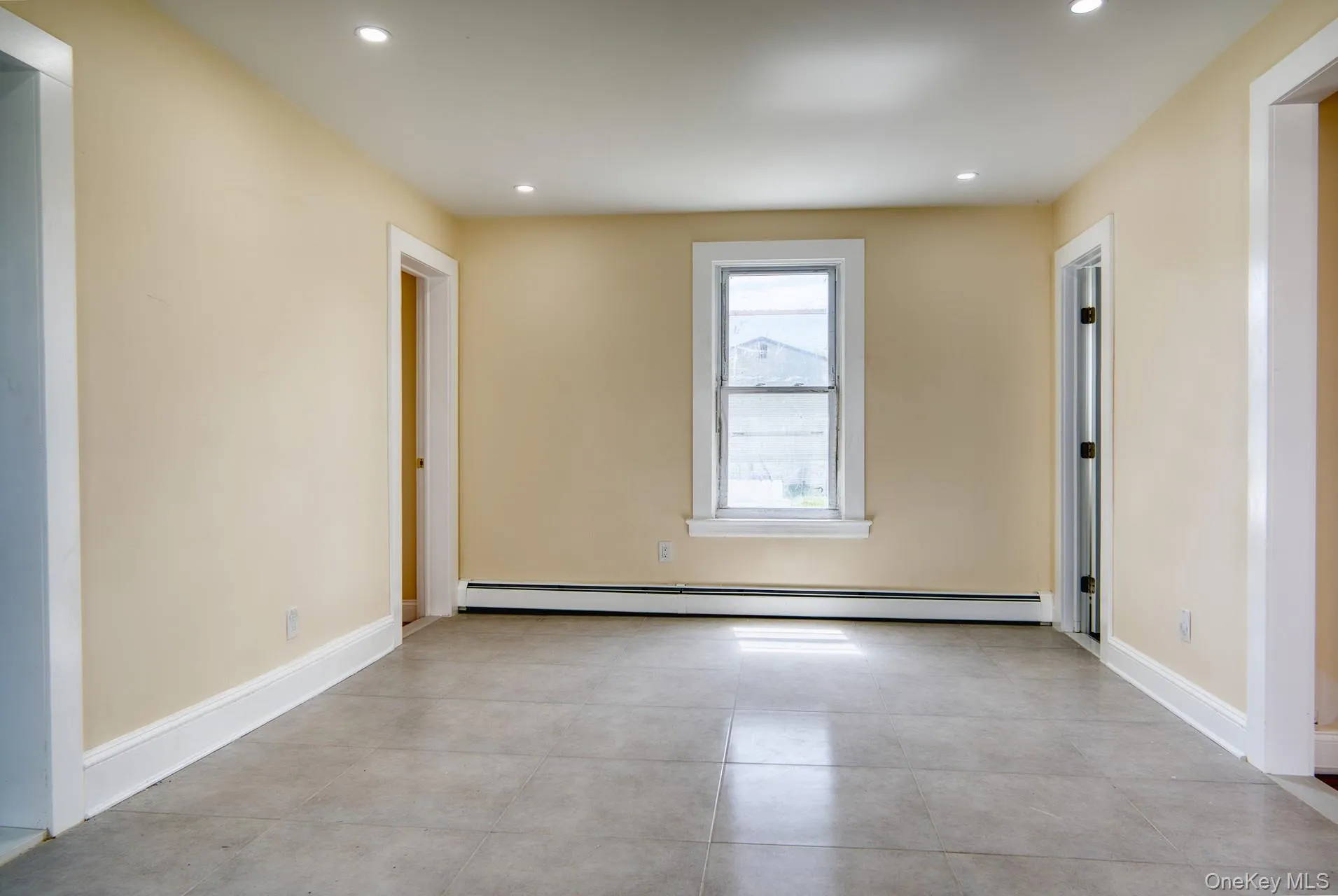Empty room featuring baseboard heating, recessed lighting, and baseboards Empty room featuring baseboard heating, recessed lighting, and baseboards