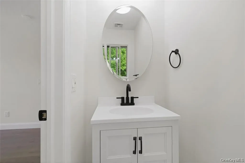 A convenient half bath with updated finishes, perfect for guests and added everyday functionality. A convenient half bath with updated finishes, perfect for guests and added everyday functionality.