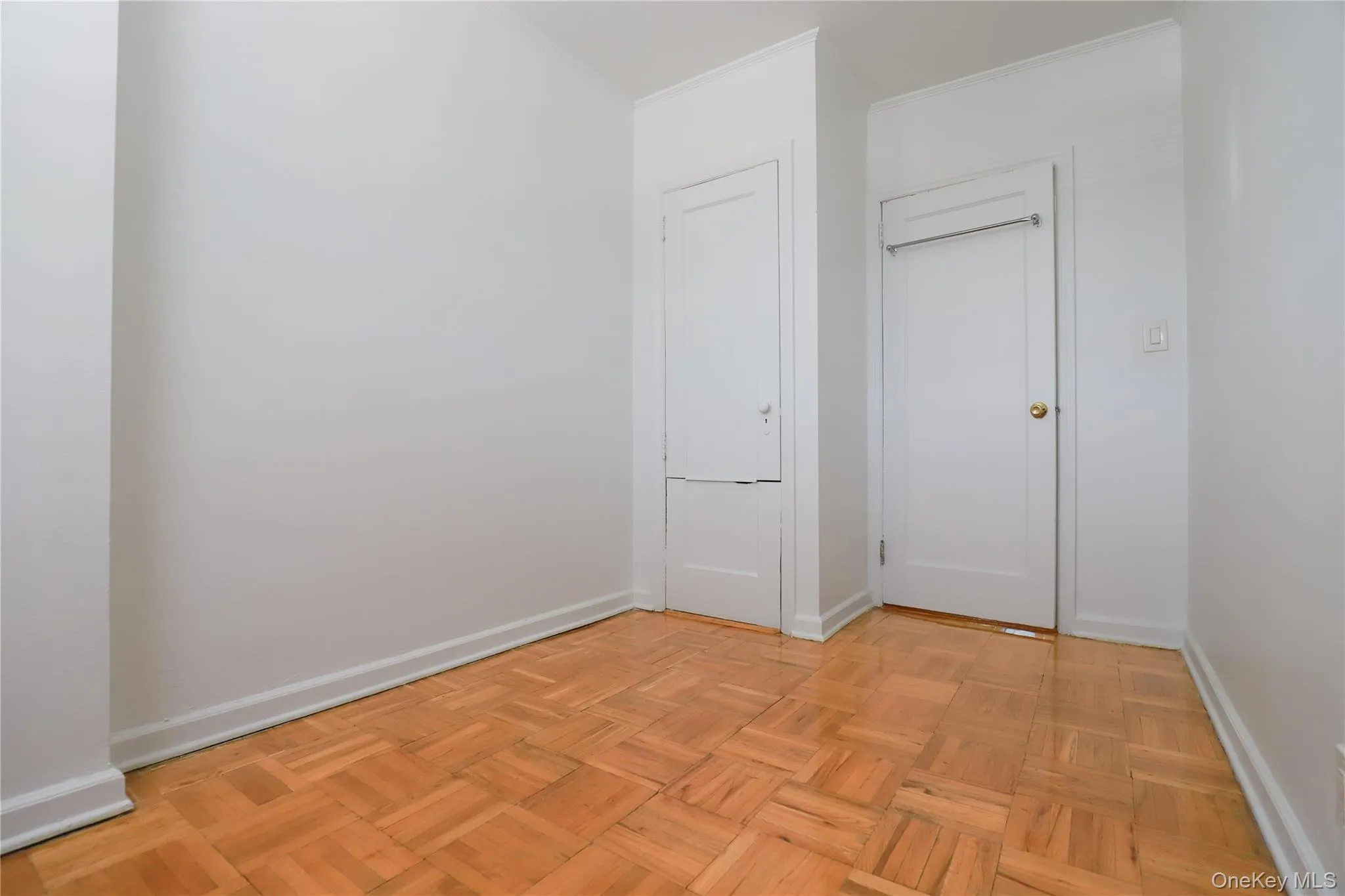 omfortable bedroom with gleaming hardwood floors, built-in closet space, and a bright window omfortable bedroom with gleaming hardwood floors, built-in closet space, and a bright window
