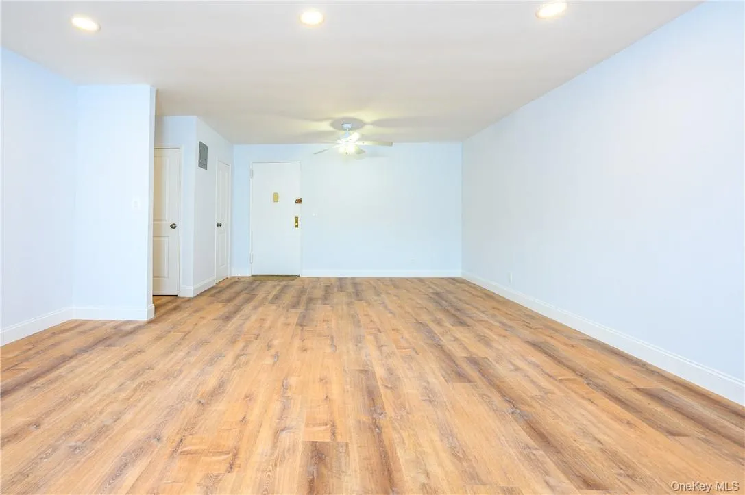 Empty room with light wood-type flooring and ceiling fan Empty room with light wood-type flooring and ceiling fan