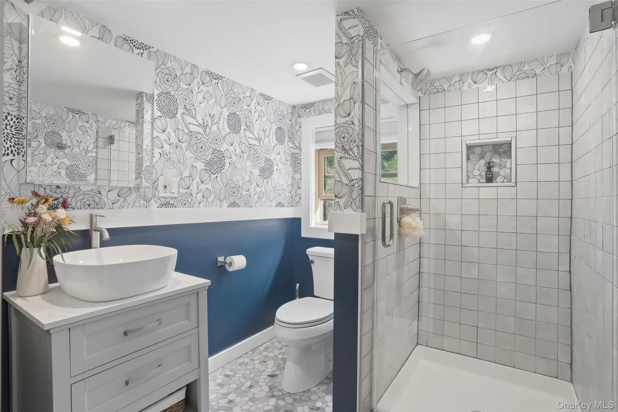Remodeled bathroom with tiled shower and gorgeous wallpaper Remodeled bathroom with tiled shower and gorgeous wallpaper