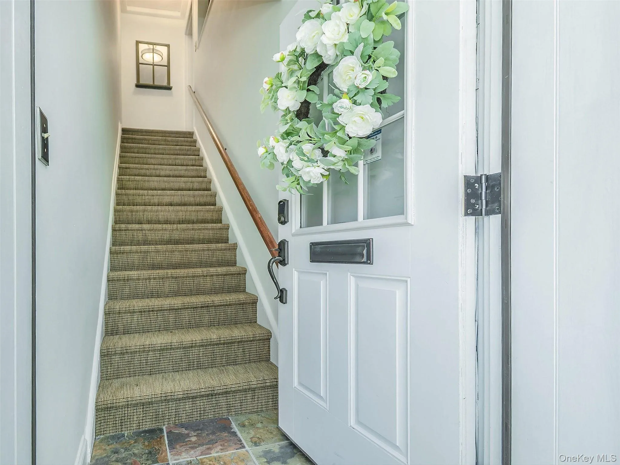 Front door leads to entry foyer and stairs to the unit Front door leads to entry foyer and stairs to the unit