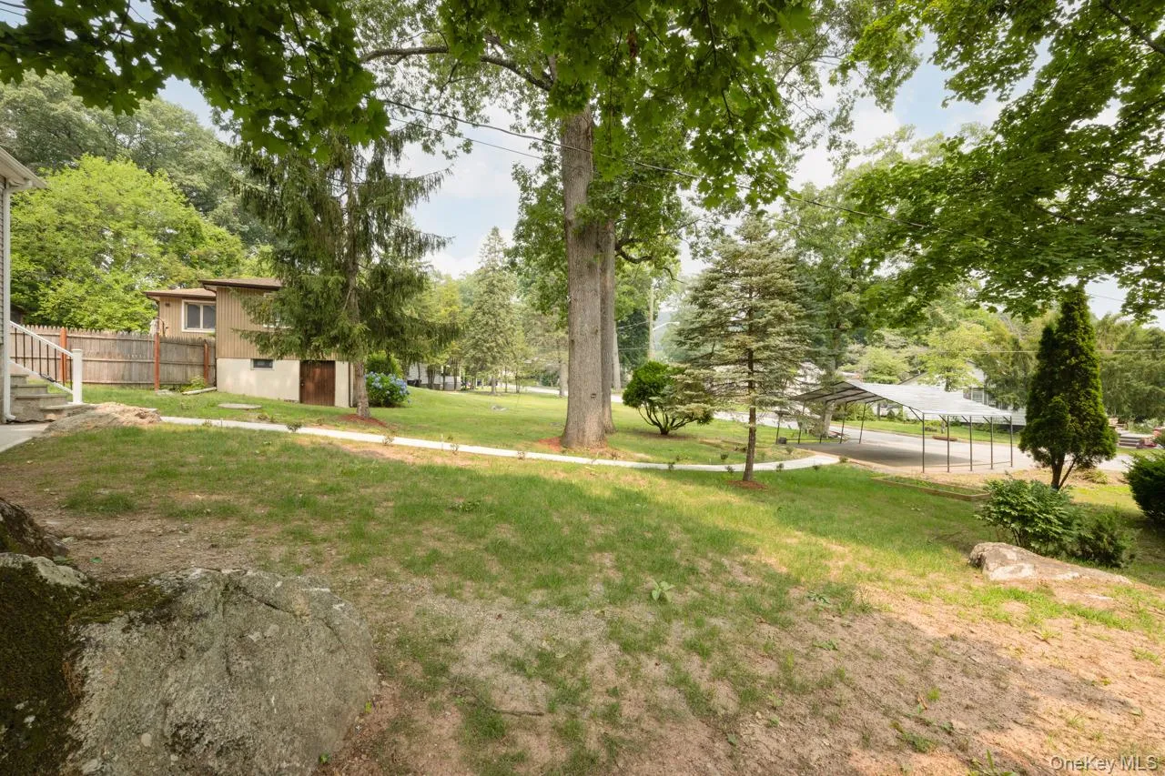Large front yard with carport Large front yard with carport