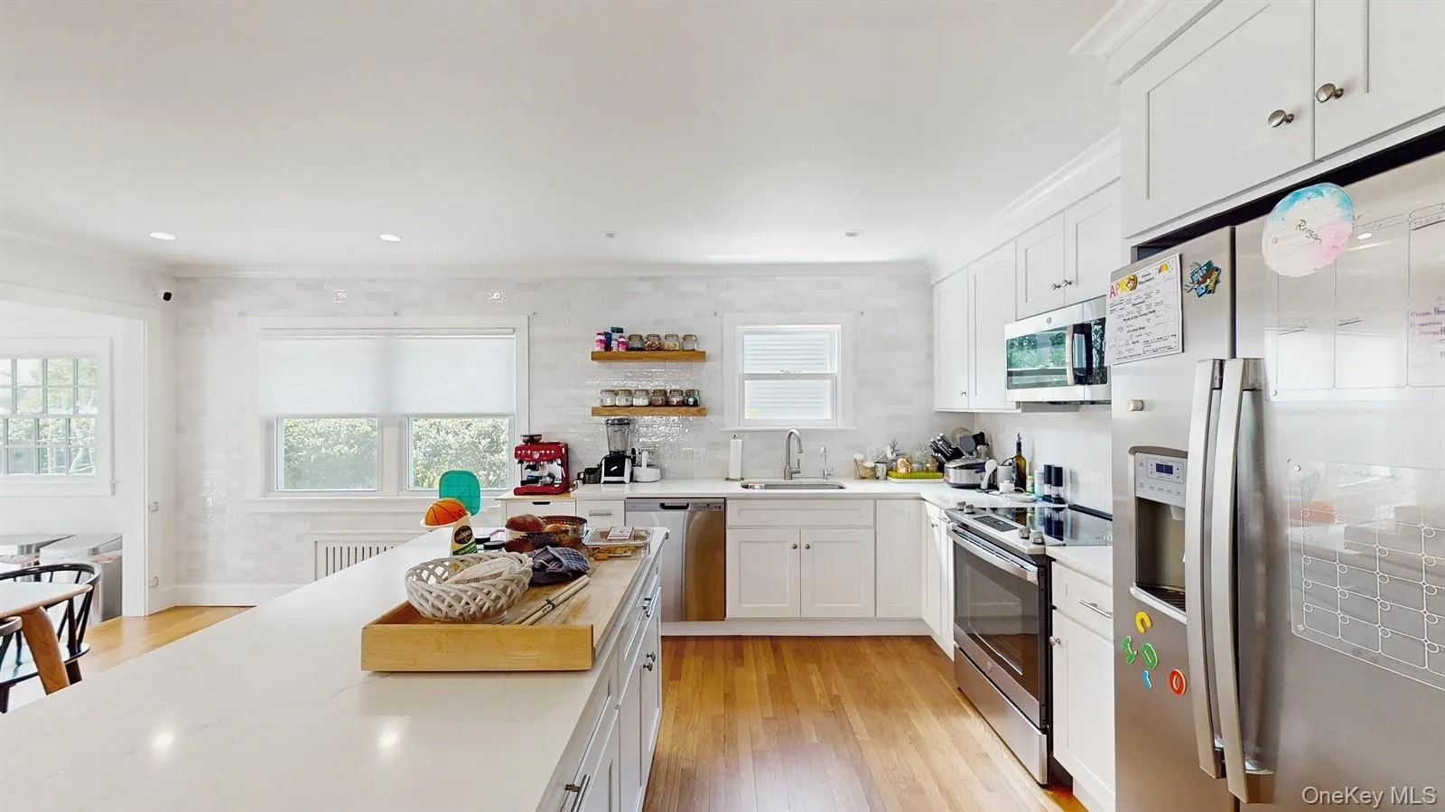Kitchen with a sink, white cabinets, appliances with stainless steel finishes, and a healthy amount of sunlight Kitchen with a sink, white cabinets, appliances with stainless steel finishes, and a healthy amount of sunlight