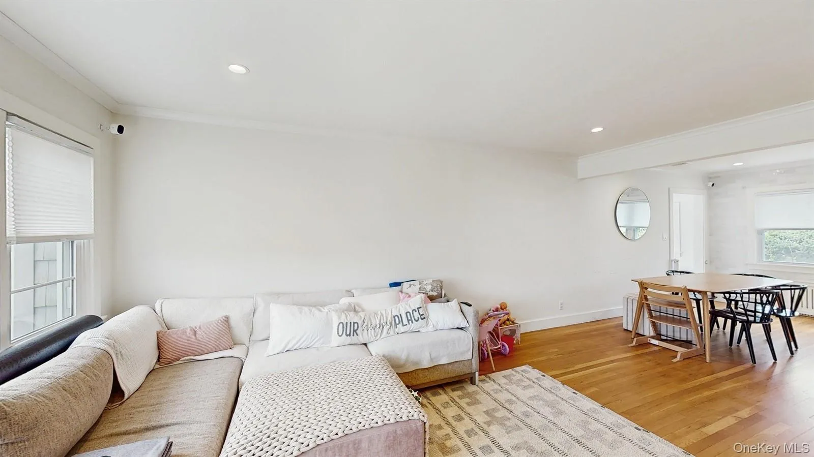 Living area featuring recessed lighting, light wood-style flooring, baseboards, and crown molding Living area featuring recessed lighting, light wood-style flooring, baseboards, and crown molding