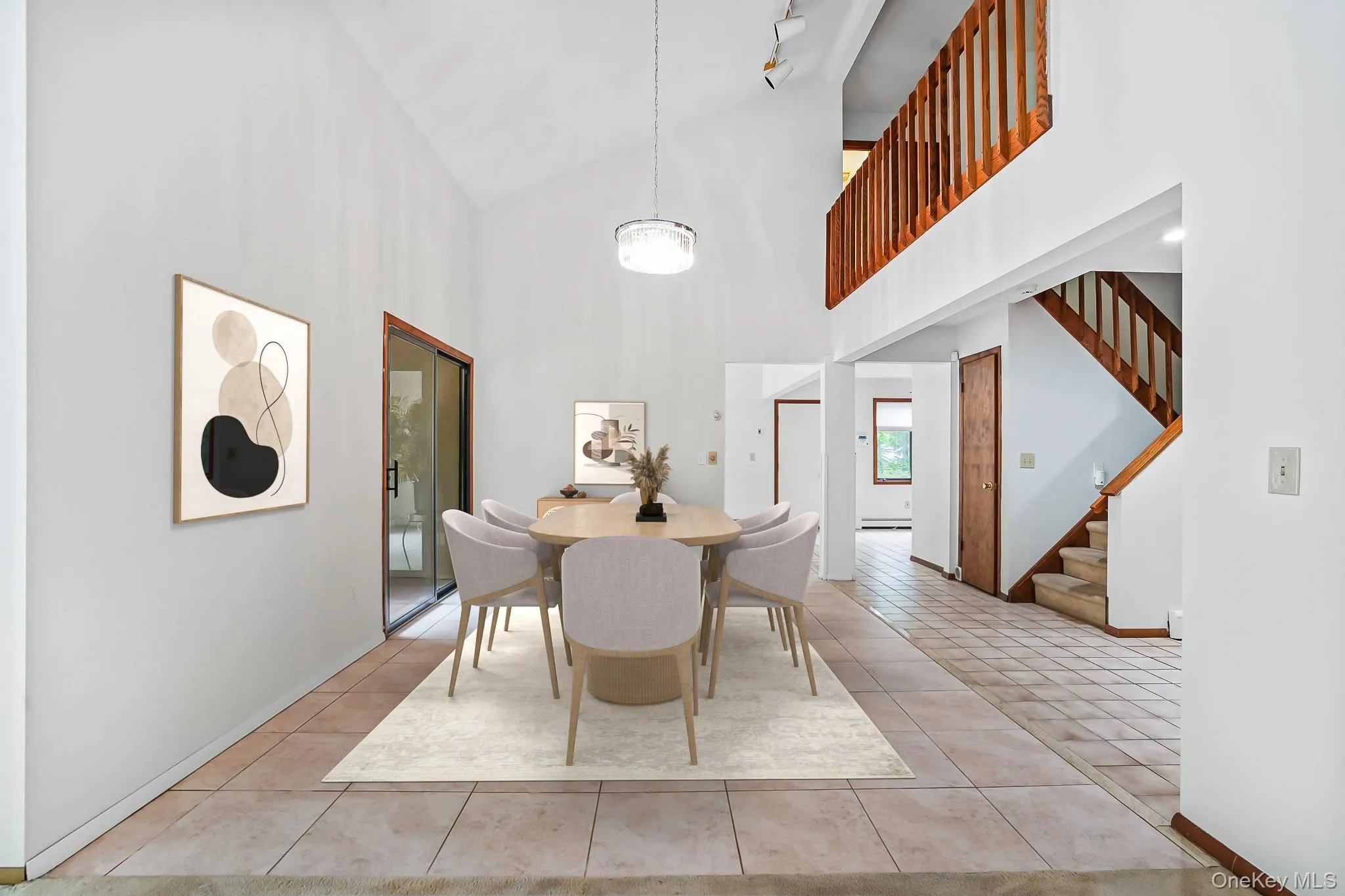 Dining area featuring a vaulted ceiling and tile flooring Dining area featuring a vaulted ceiling and tile flooring