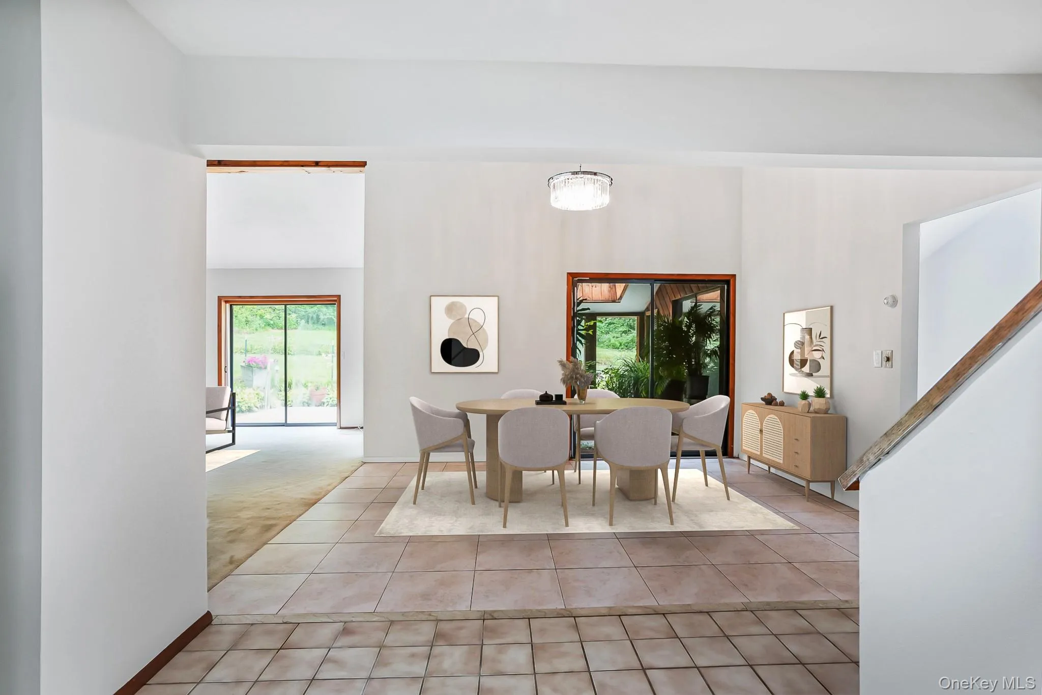 Dining area featuring vaulted ceilings, a contemporary chandelier, and large windows Dining area featuring vaulted ceilings, a contemporary chandelier, and large windows