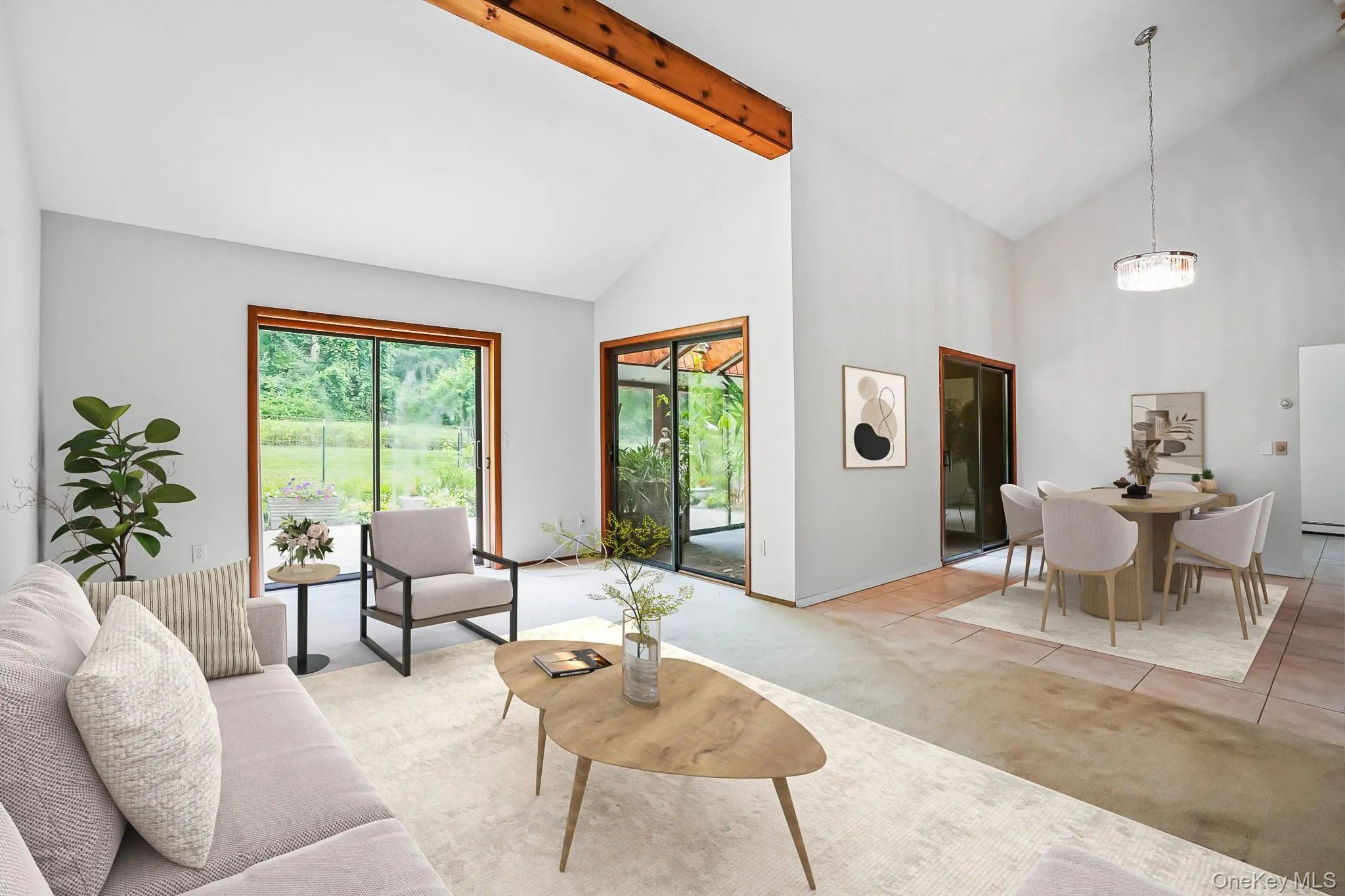 Vaulted ceilings featuring an exposed wood beam, large sliding glass doors, and a dining area with a contemporary chandelier Vaulted ceilings featuring an exposed wood beam, large sliding glass doors, and a dining area with a contemporary chandelier