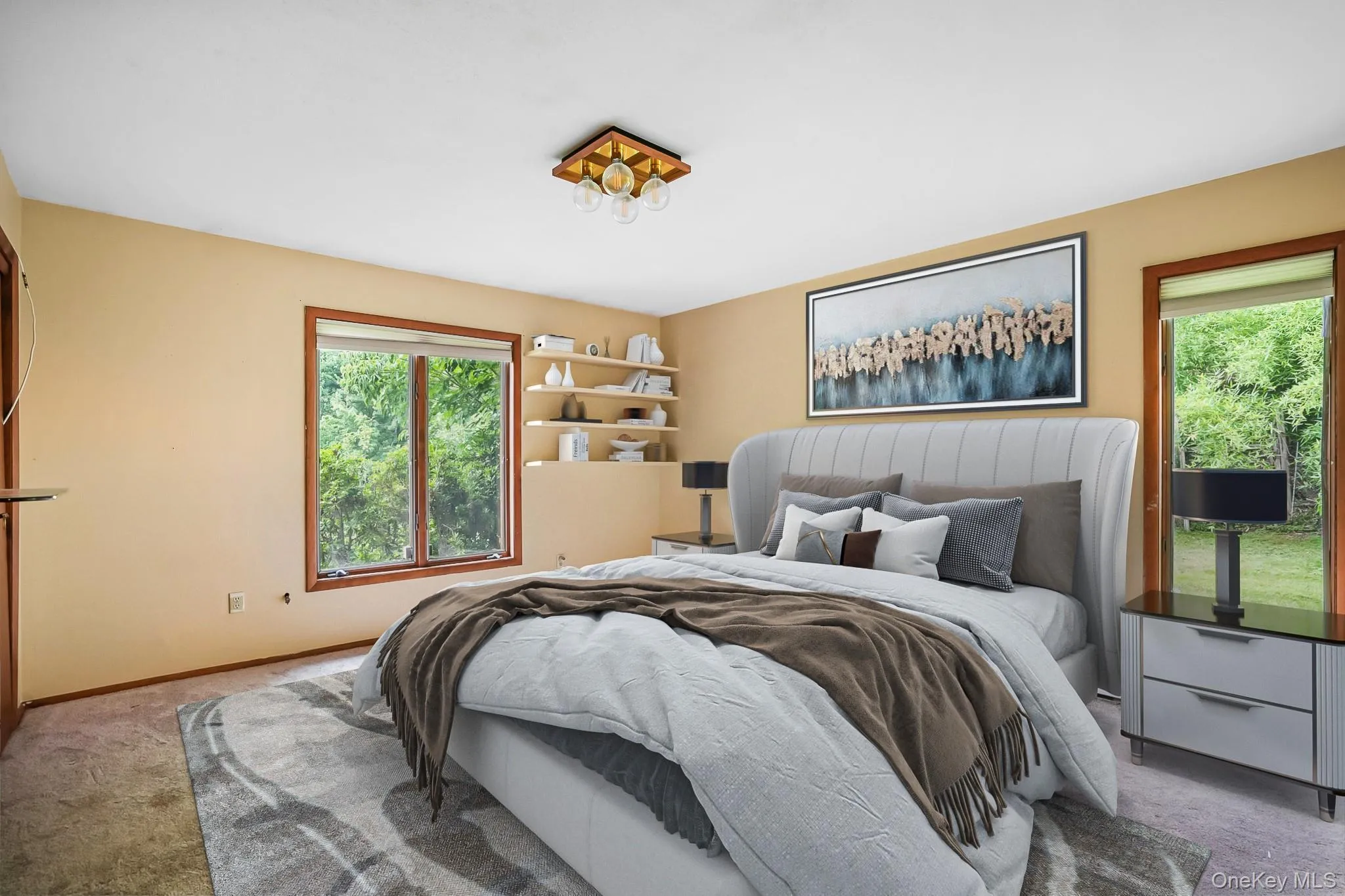 Bright room featuring dual windows with wood trim, built-in shelving, a flush-mount ceiling light fixture, and warm-toned wall paint Bright room featuring dual windows with wood trim, built-in shelving, a flush-mount ceiling light fixture, and warm-toned wall paint