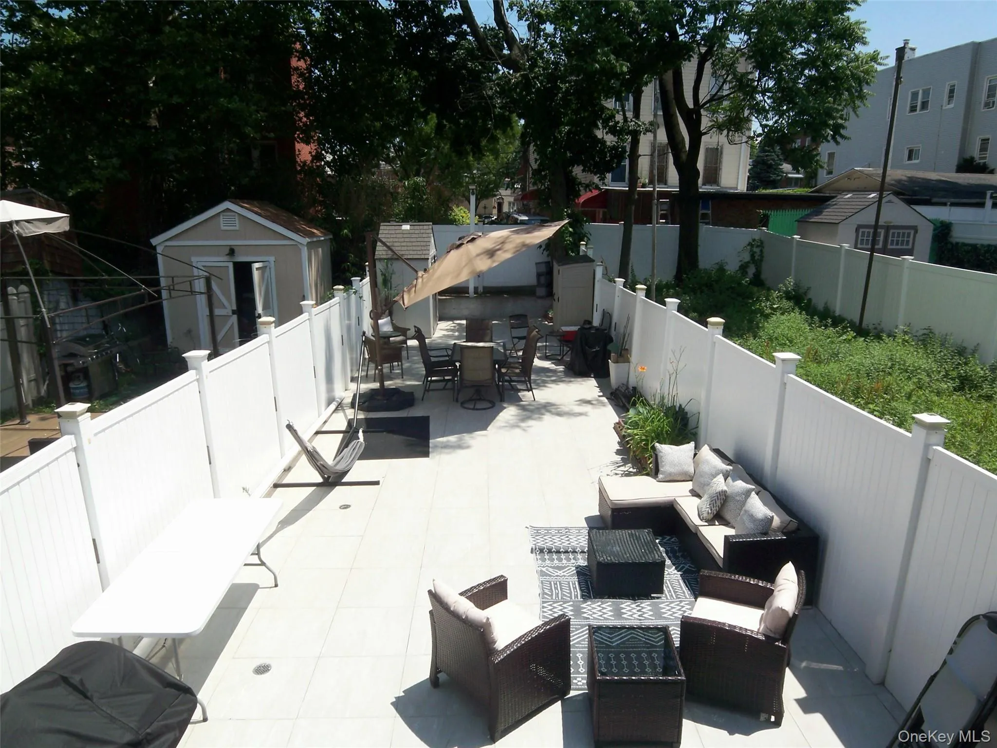 Expansive patio featuring light-colored tile flooring Expansive patio featuring light-colored tile flooring