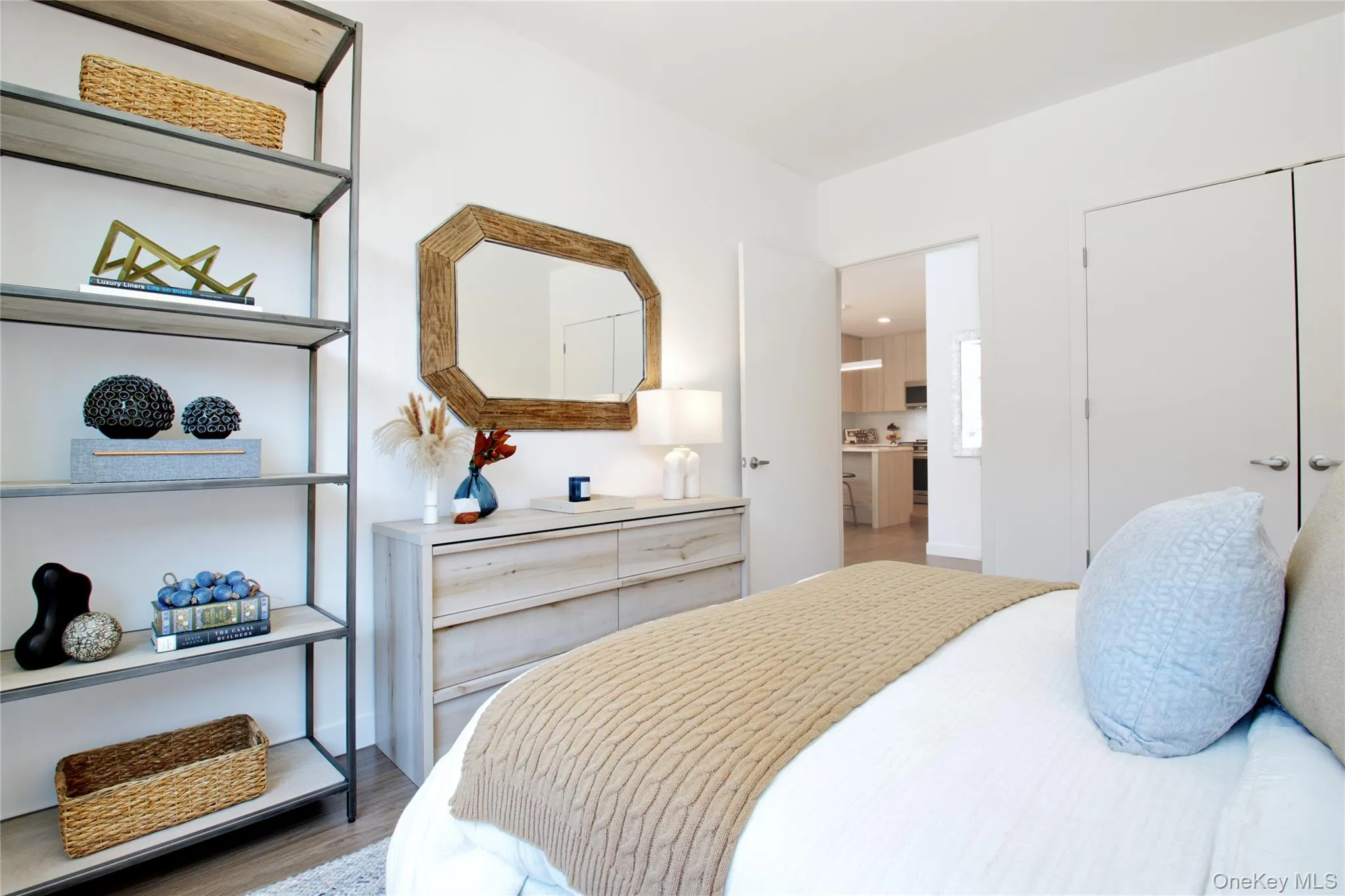 Bedroom featuring light wood-style flooring and a closet Bedroom featuring light wood-style flooring and a closet