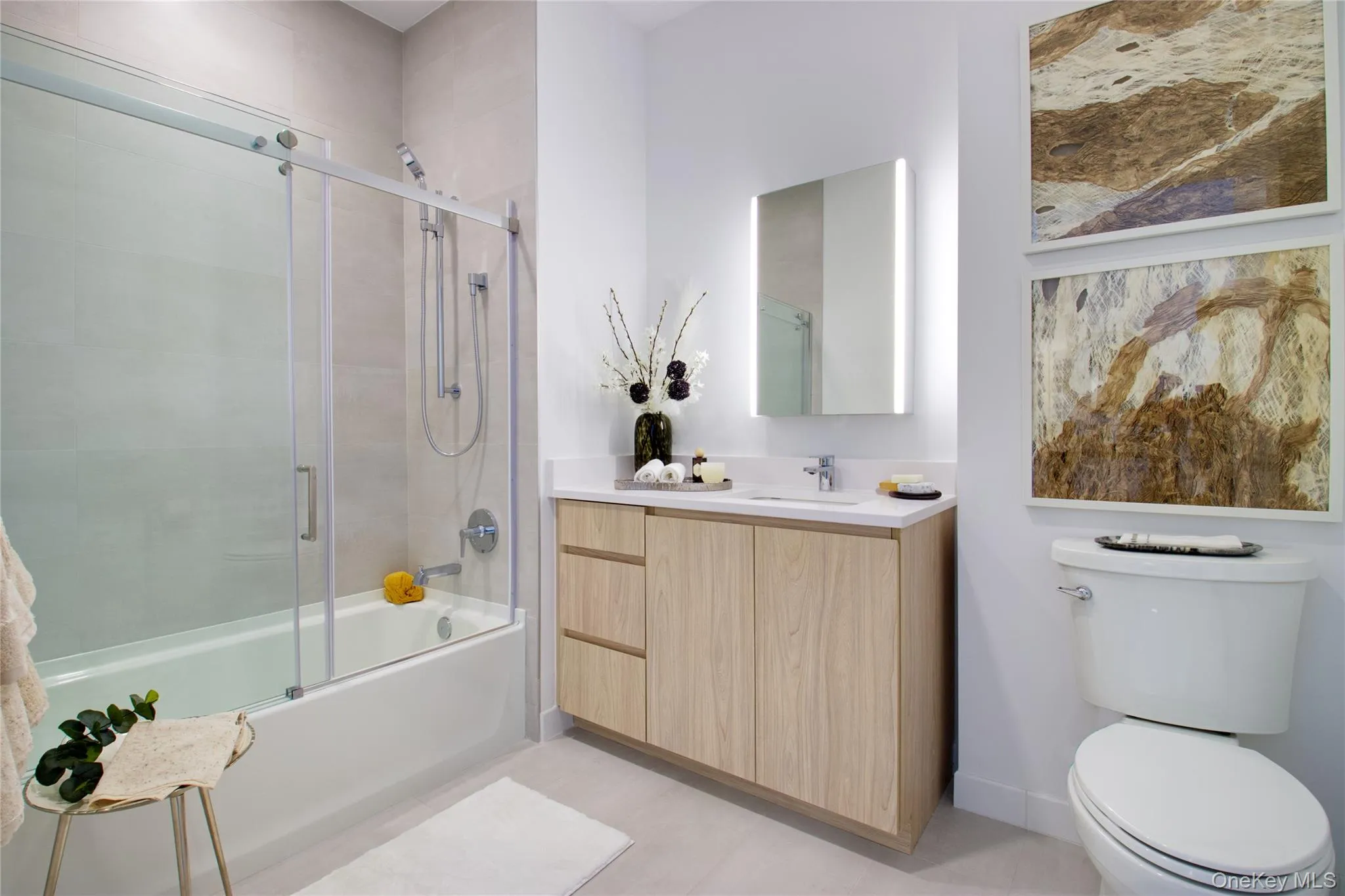 Bathroom with combined bath / shower with glass door and vanity Bathroom with combined bath / shower with glass door and vanity