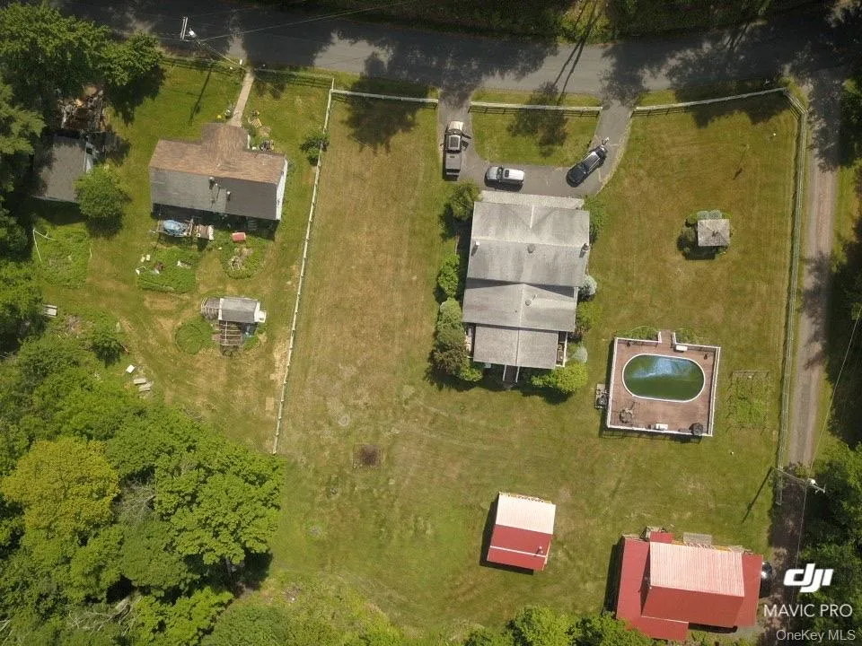 Expansive property featuring multiple structures, a paved drive, and an in-ground pool Expansive property featuring multiple structures, a paved drive, and an in-ground pool