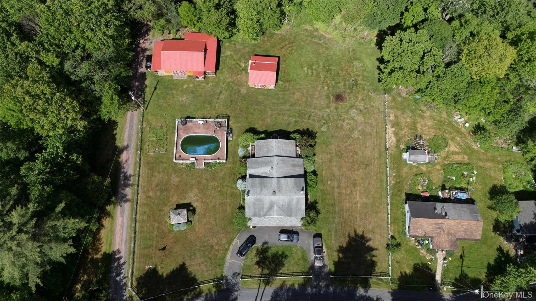 Aerial perspective highlighting a residential property with surrounding green space Aerial perspective highlighting a residential property with surrounding green space