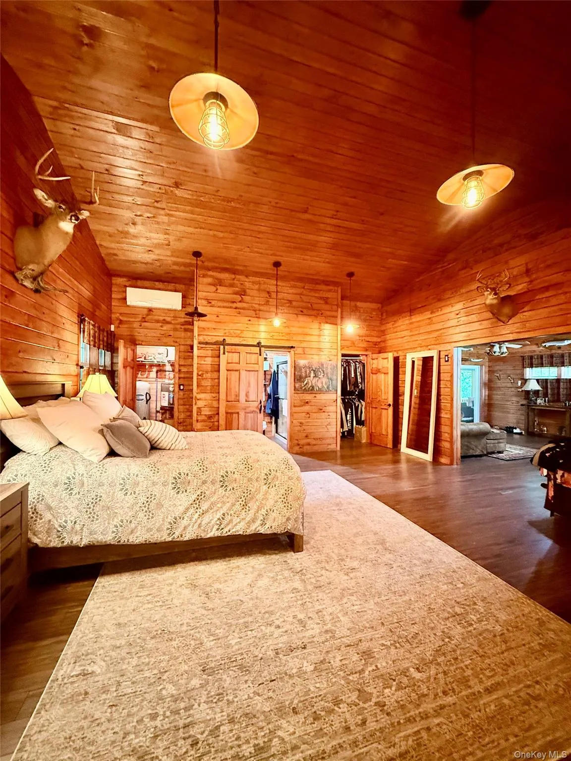 Wood-paneled room featuring a vaulted ceiling and exposed wood beams Wood-paneled room featuring a vaulted ceiling and exposed wood beams