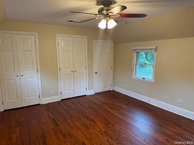 Large Bedroom with wood floors and plenty of closets Large Bedroom with wood floors and plenty of closets