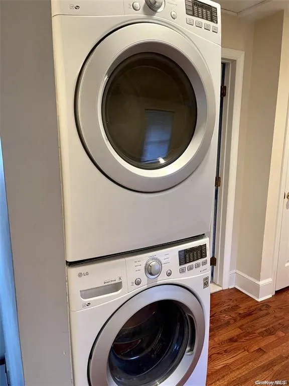 Stackable front-loading washer and dryer set on wood-finish flooring Stackable front-loading washer and dryer set on wood-finish flooring