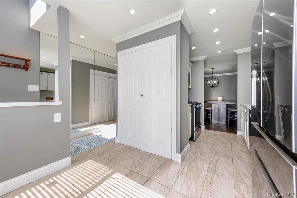 Kitchen with crown molding, recessed lighting, baseboards, and stainless steel gas range Kitchen with crown molding, recessed lighting, baseboards, and stainless steel gas range