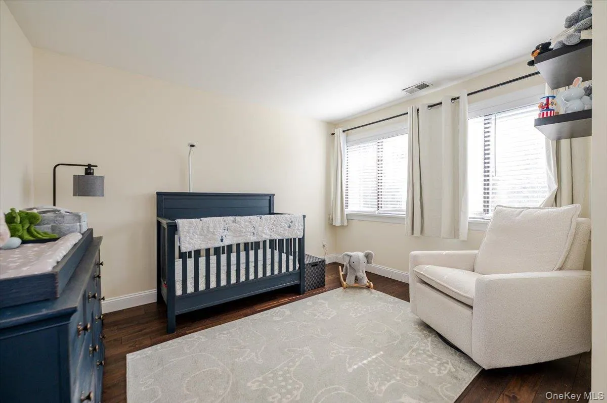 Bedroom with baseboards, wood finished floors, and multiple windows. Bedroom with baseboards, wood finished floors, and multiple windows.