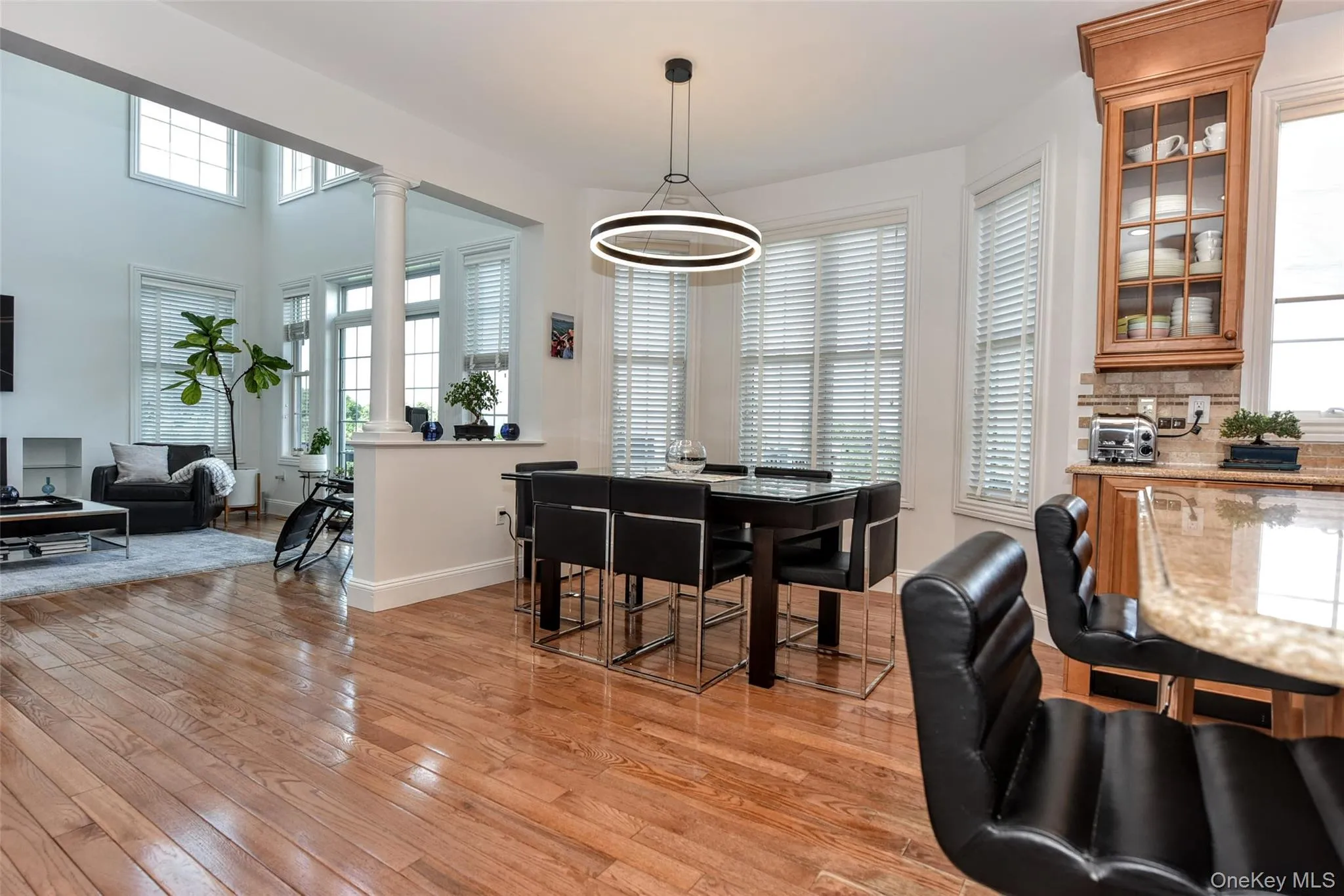Open-concept living space with wood-finish flooring Open-concept living space with wood-finish flooring