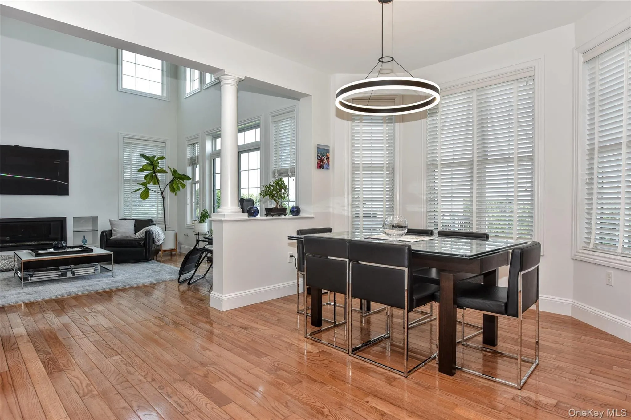 Open-concept living and dining areas featuring hardwood flooring throughout Open-concept living and dining areas featuring hardwood flooring throughout