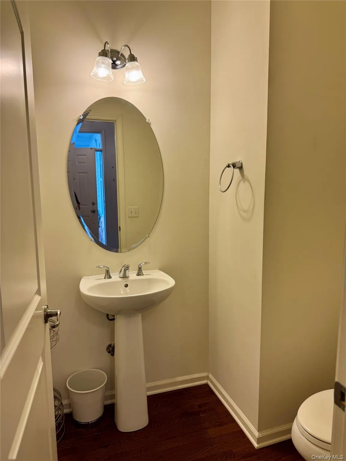 Bathroom with wood finished floors and baseboards Bathroom with wood finished floors and baseboards