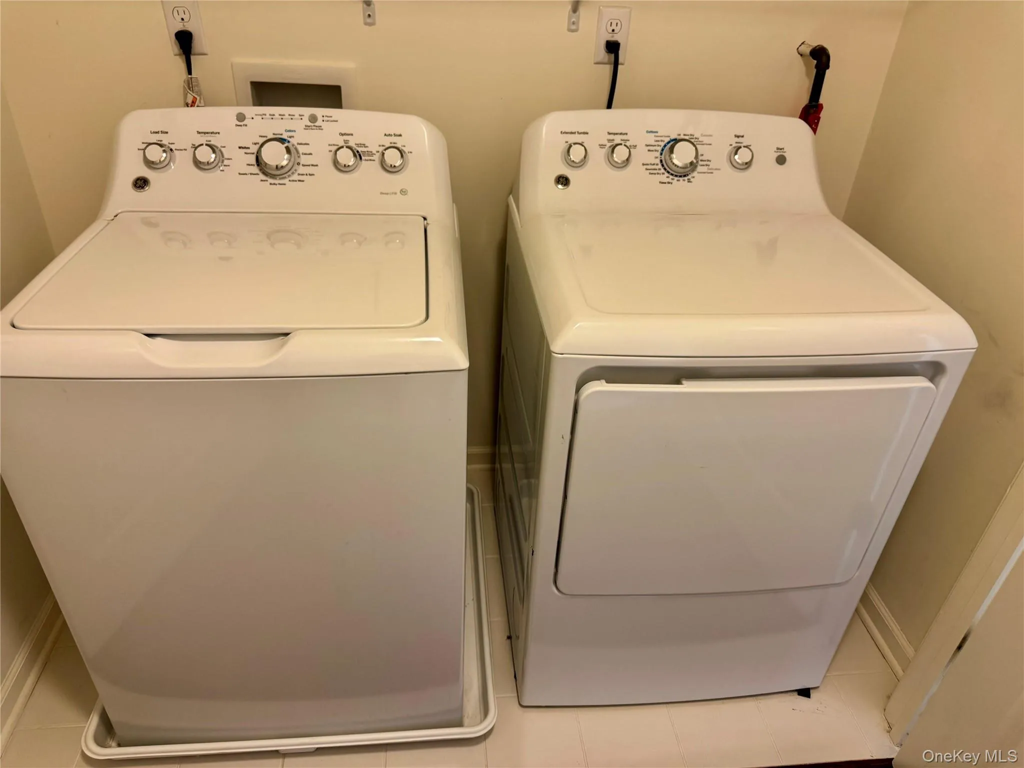 Laundry room featuring washer and dryer and tile patterned flooring Laundry room featuring washer and dryer and tile patterned flooring